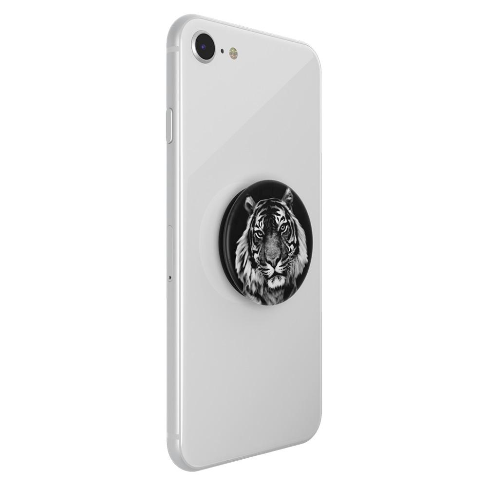 Weißes Telefon mit einem Tiger-Popsocket, Seitenansicht. Schwarz-Weiß-Bild.