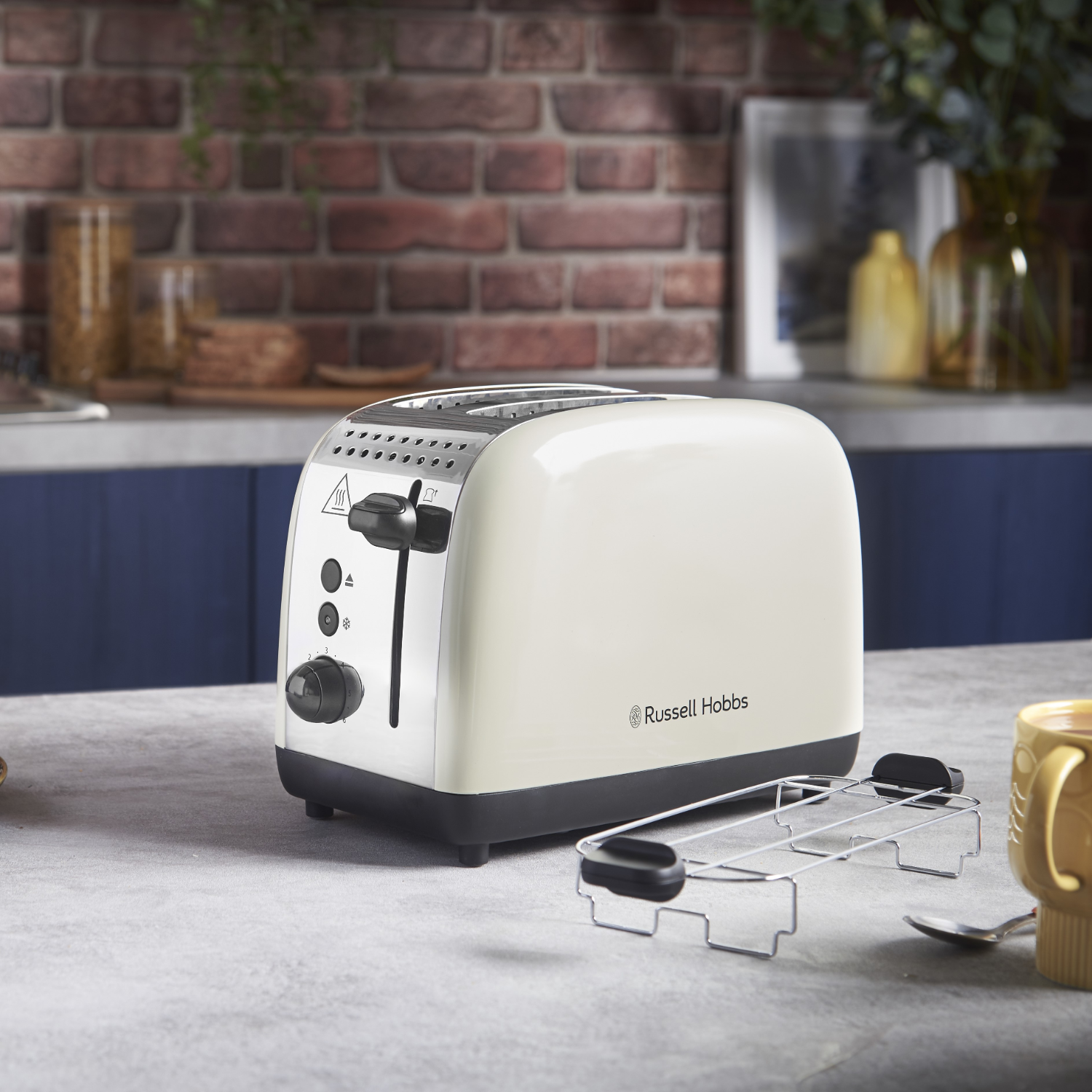 Off-white Russell Hobbs toaster with a silver rack. Kitchen setting.