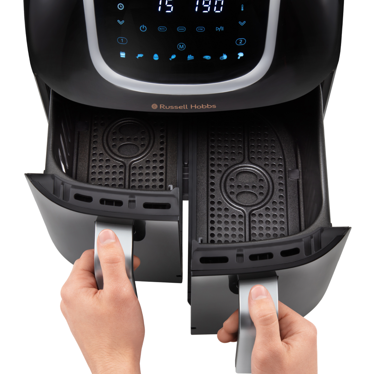 Black air fryer, trays open. Hands pull out trays. Digital display on top shows settings. Russell Hobbs brand name is visible.