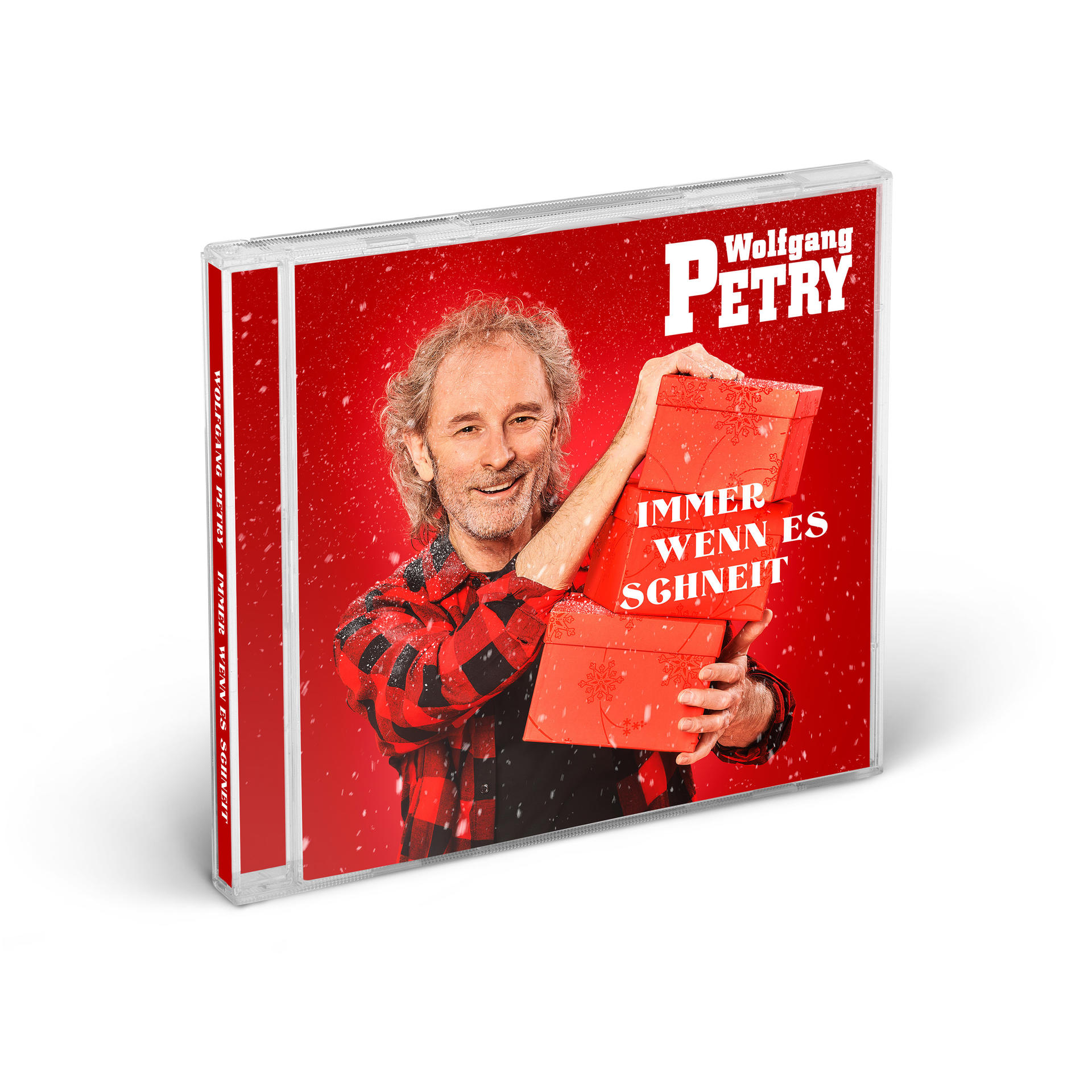 CD-Hülle mit Mann, der rote Boxen hält. Text: 'Immer wenn es schneit' und 'Wolfgang Petry'.