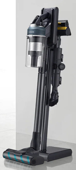 Czarny i srebrny odkurzacz stoi pionowo, z przezroczystym pojemnikiem na kurz.