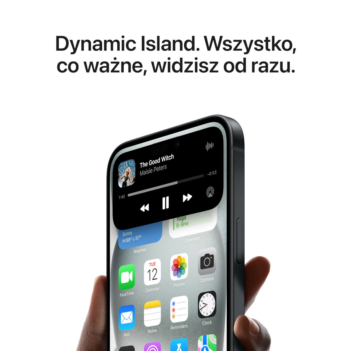 Ręka trzyma telefon z Dynamic Island, pokazując kontrolę muzyki i aplikacje.