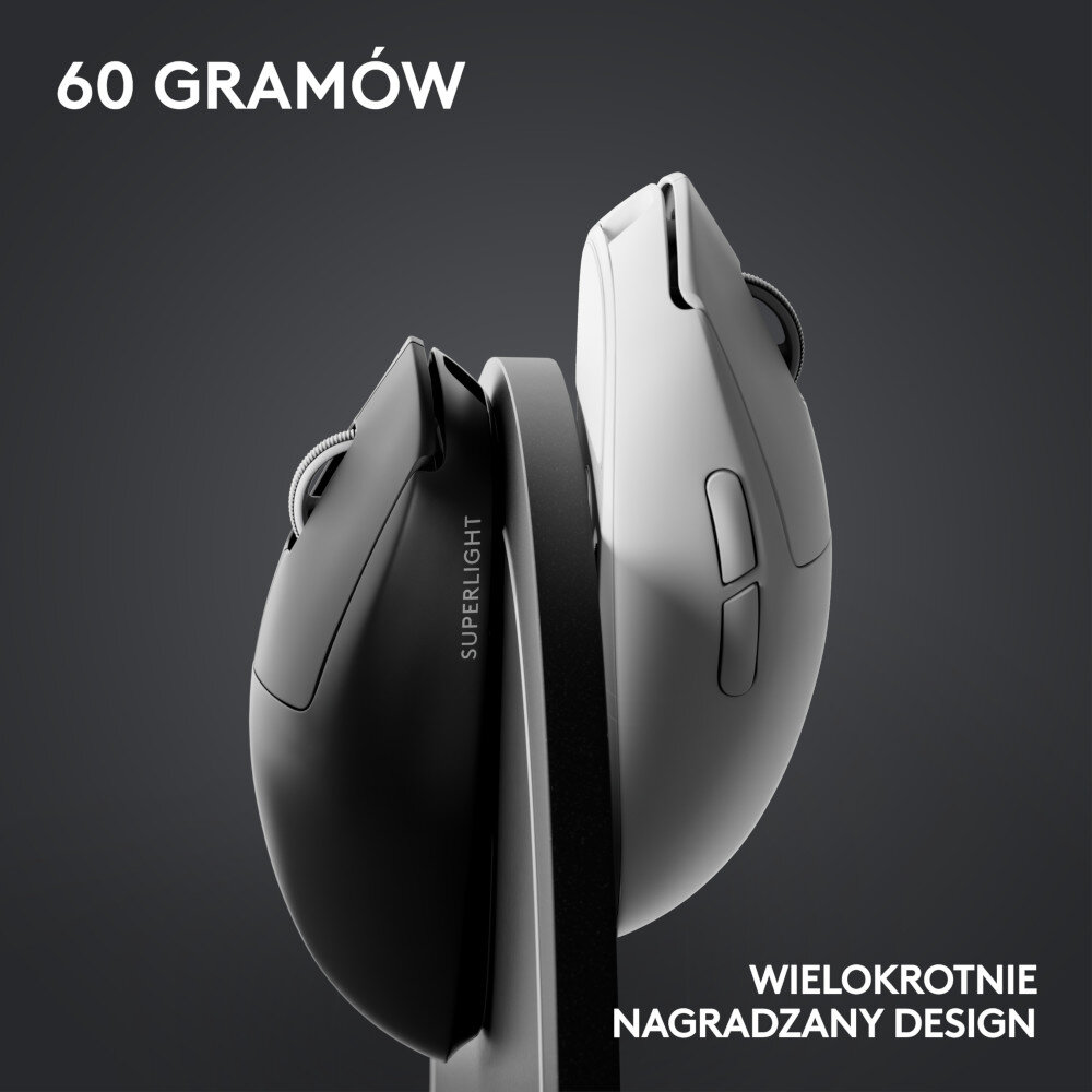 Dwie myszy komputerowe, czarna i biała, umieszczone na stacji ładującej.