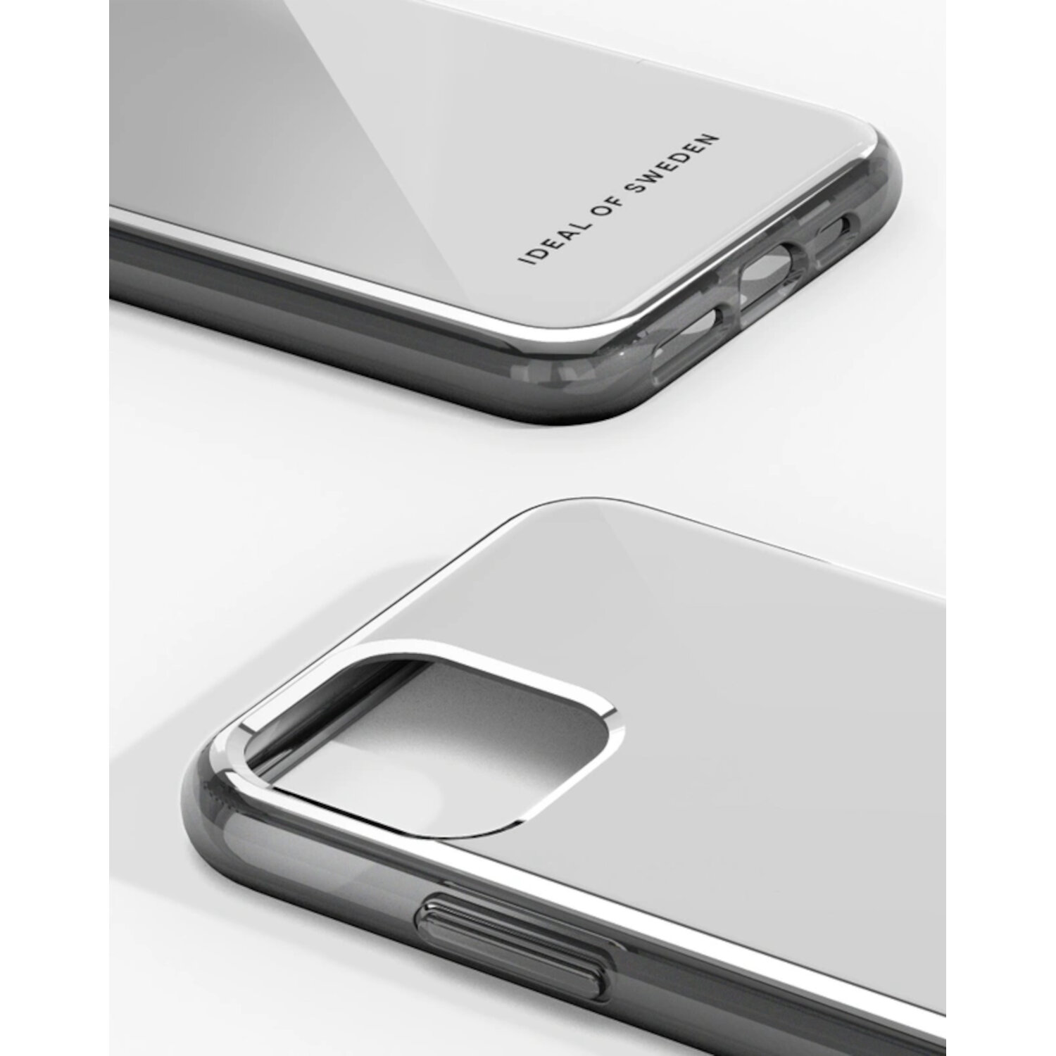 Gros plan d'une coque de téléphone grise avec un cadre argenté. Texte: 'IDEAL OF SWEDEN'.