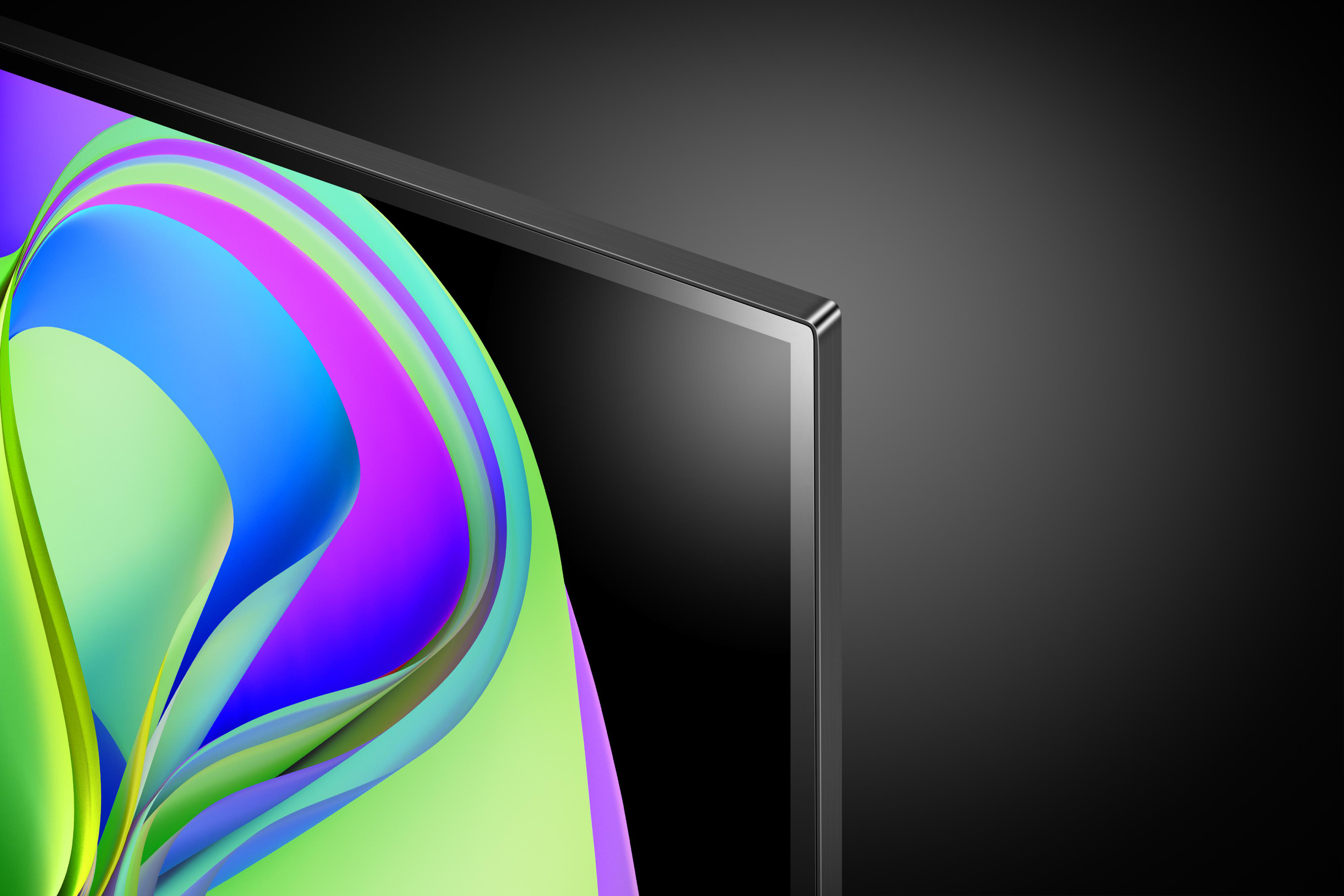 Nahaufnahme einer TV-Bildschirmecke mit bunten abstrakten Formen auf schwarzem Hintergrund.