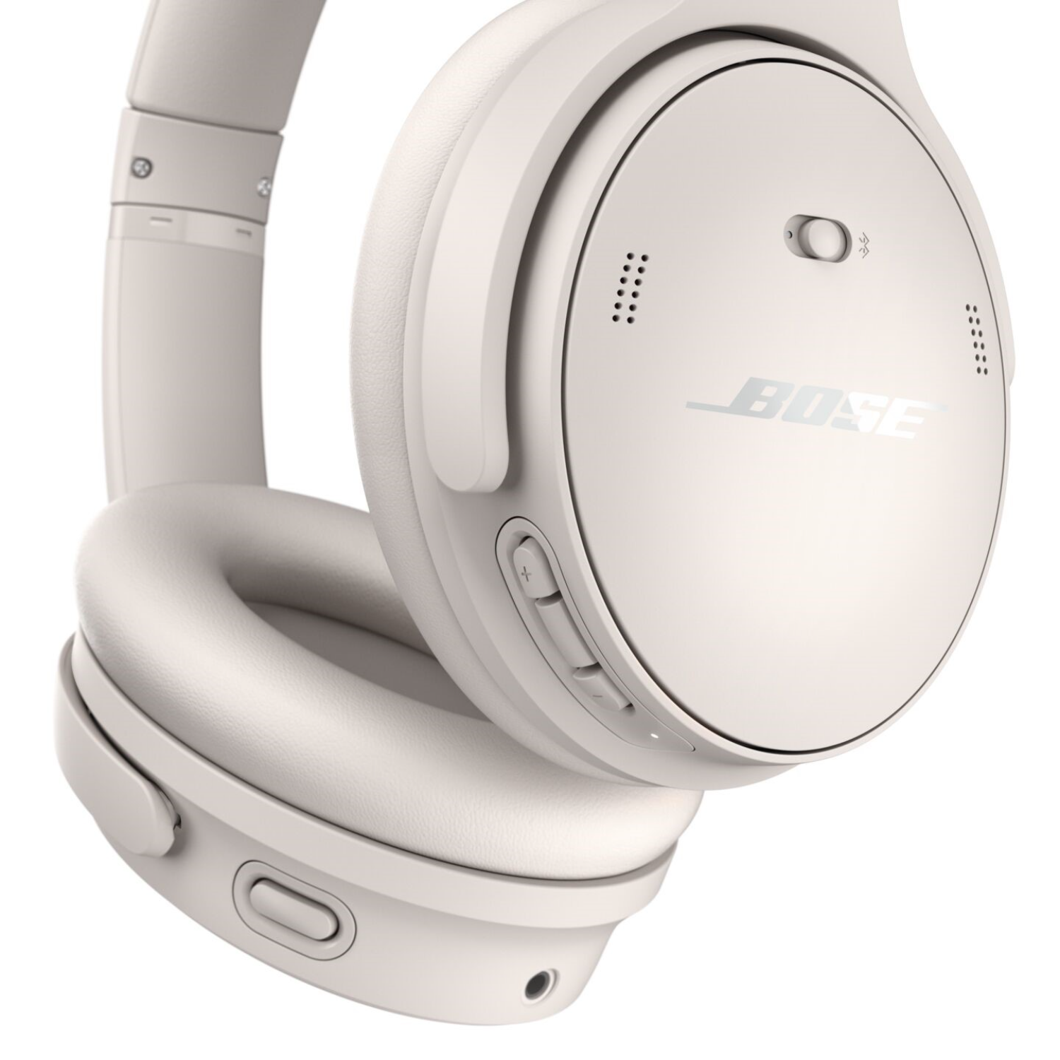 Off-white, over-ear headphones with the Bose logo. The headphones are angled forward.
