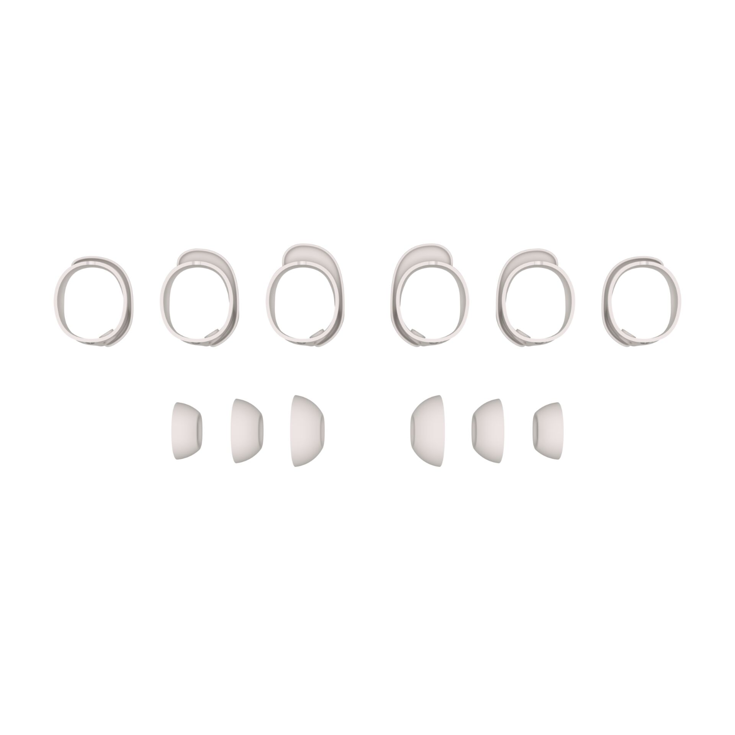 Six white ear tips and ear inserts for headphones, arranged on a white background.