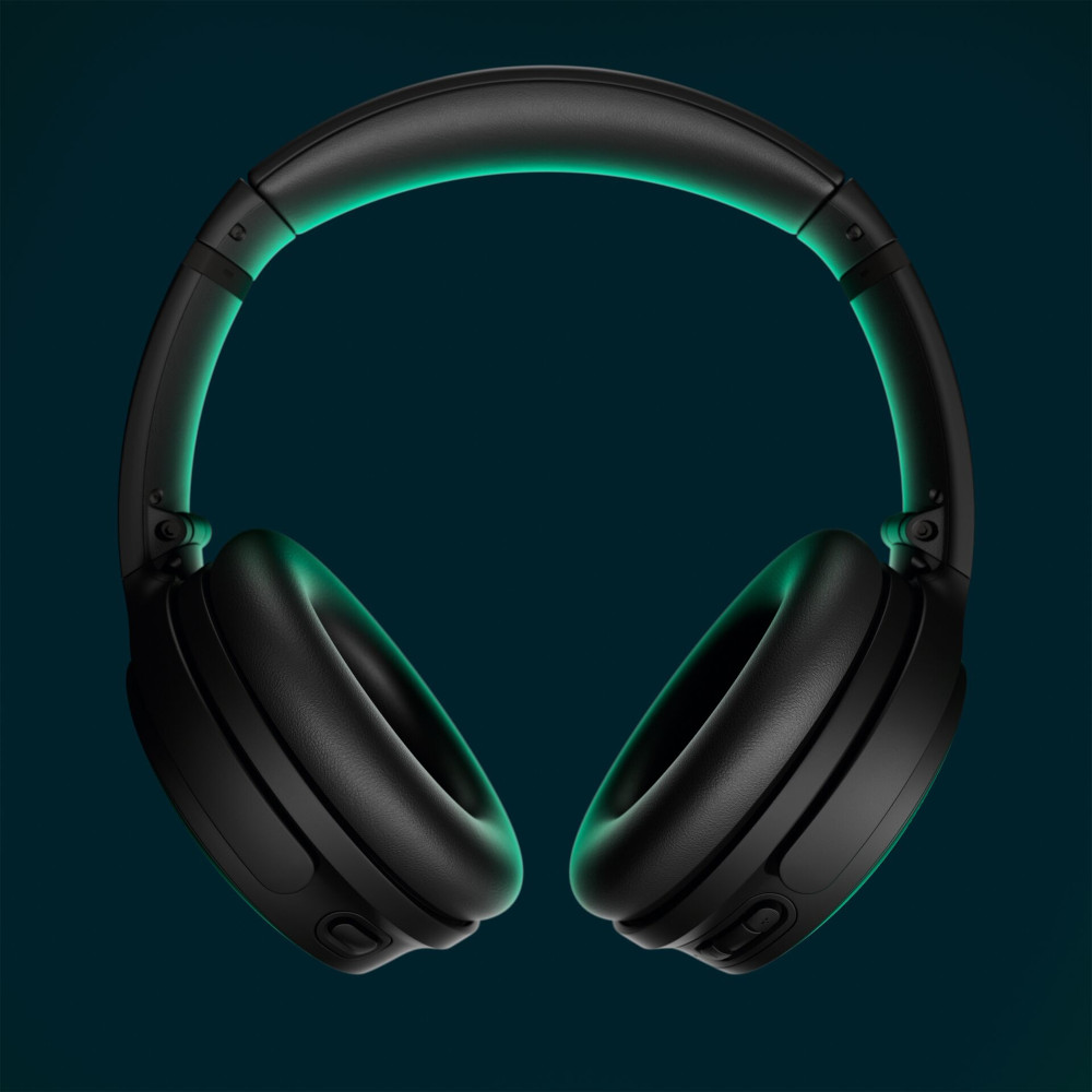 Black headphones with a teal glow, against a dark background.