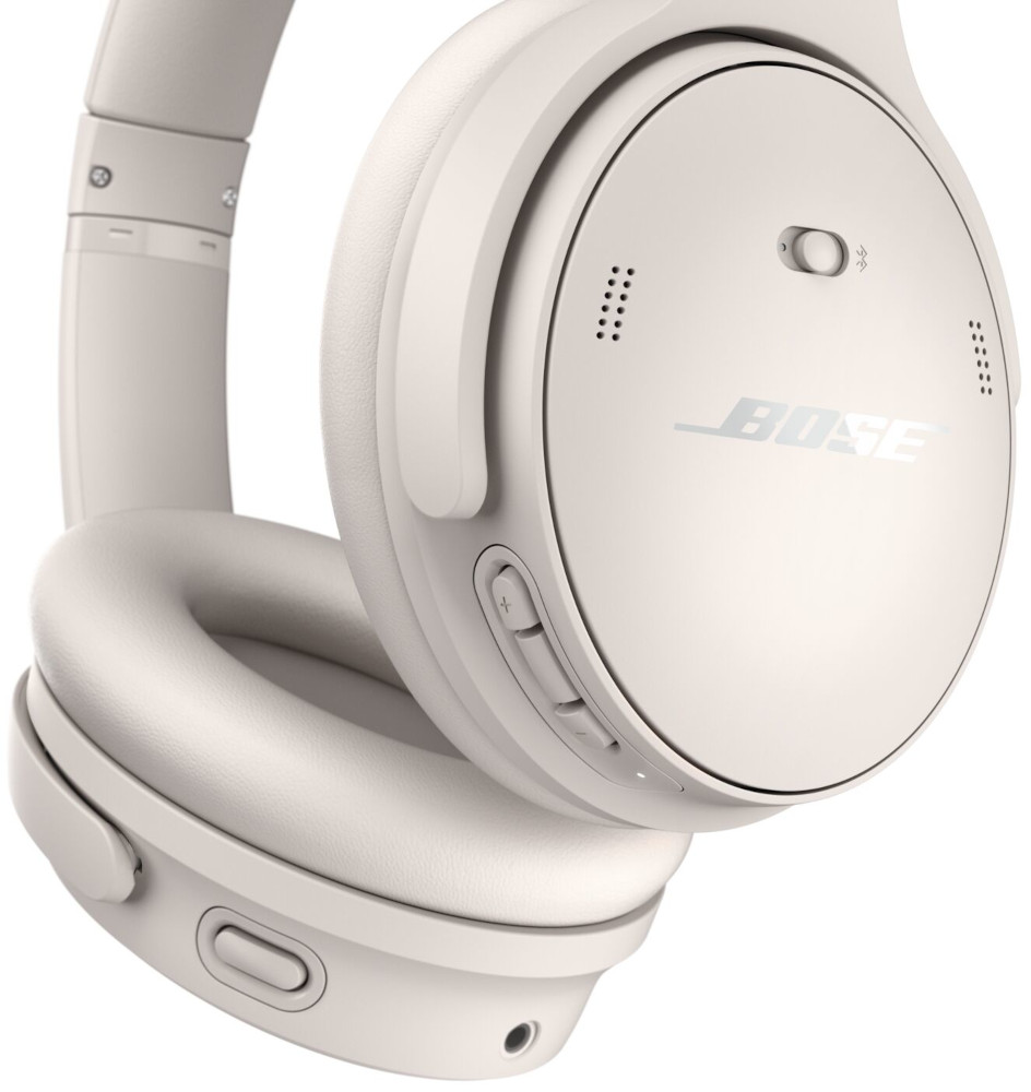 Cream-colored Bose headphones, with buttons and the brand name visible.