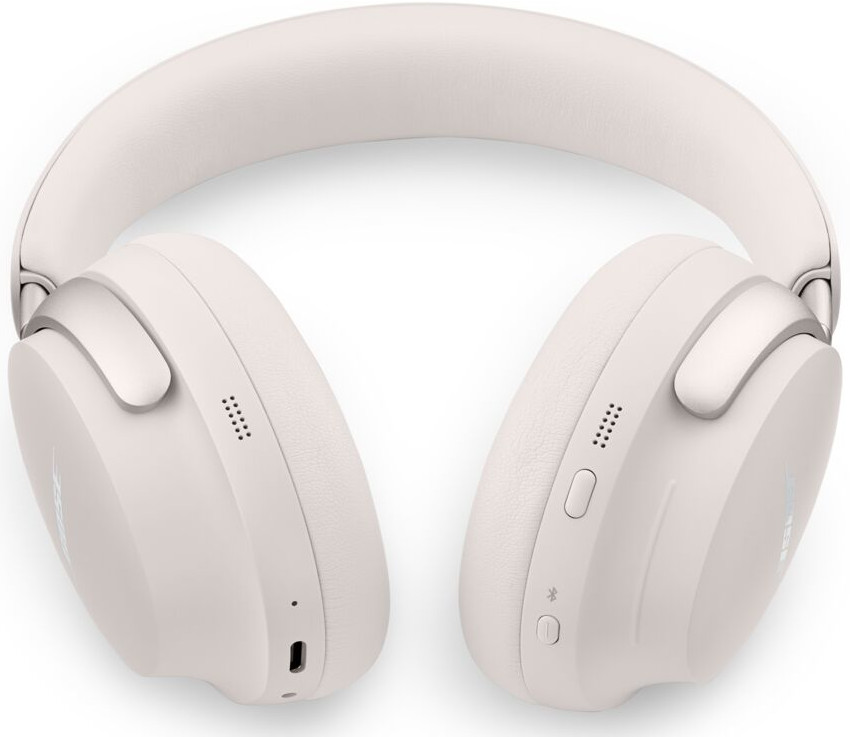 Witte koptelefoon. Oorschelpen en hoofdband zichtbaar, met knoppen op de rechter oorschelp.