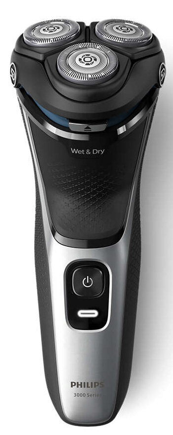 Golarka elektryczna. Czarno-srebrny design. Trzy głowice obrotowe. Zawiera przycisk zasilania.