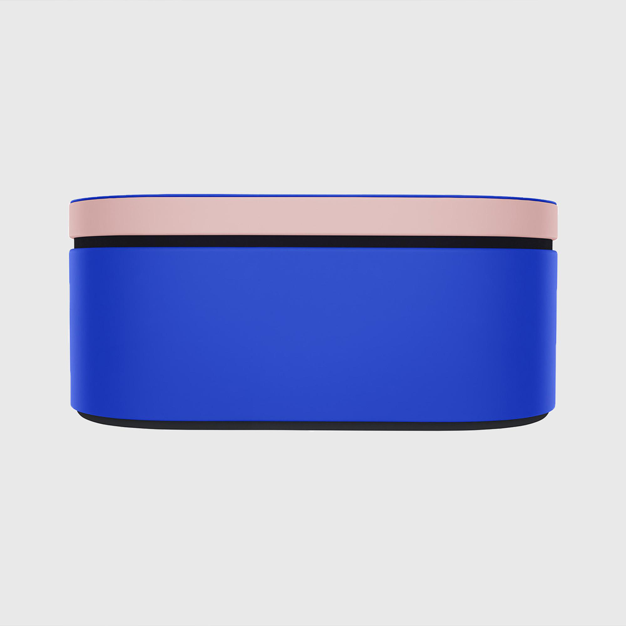 Eine blaue rechteckige Box mit einem rosa und blauen Deckel. Der Hintergrund ist hellgrau.
