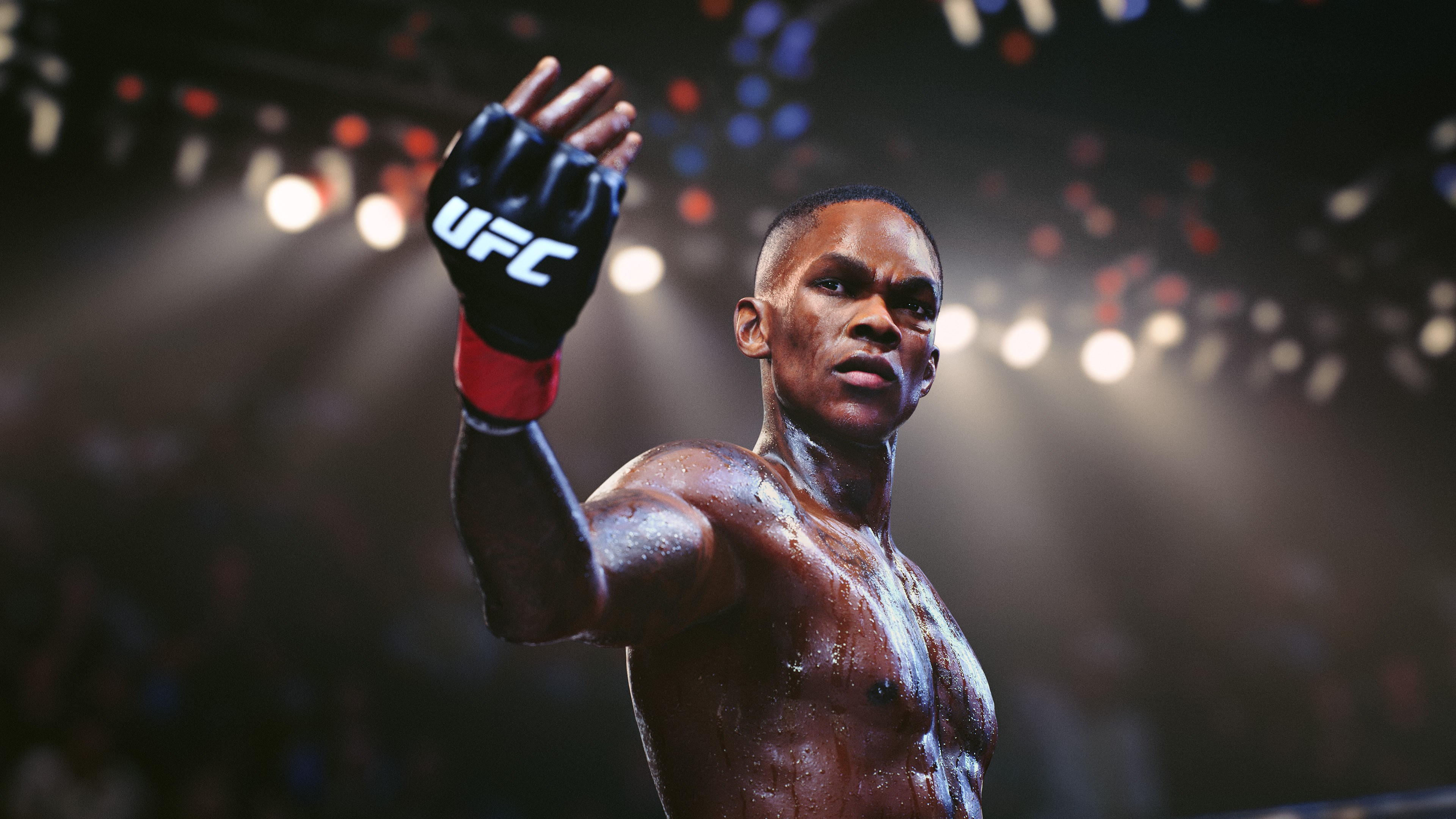 Ein Kämpfer im Ring, die behandschuhte Hand erhoben. UFC-Logo sichtbar, helle Lichter im Hintergrund.