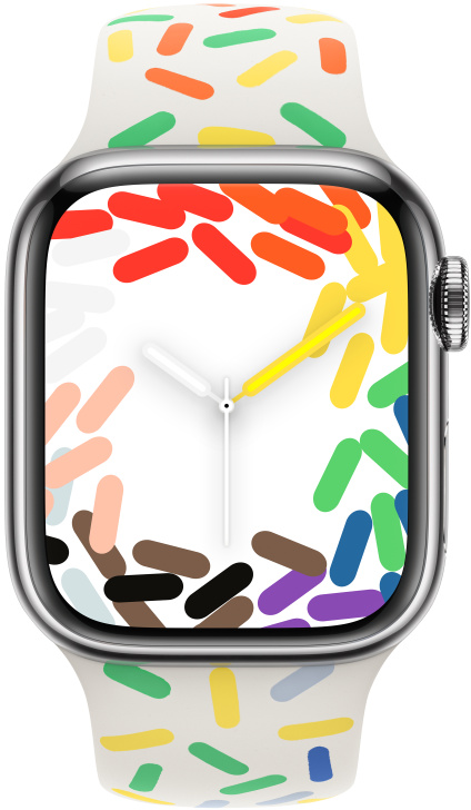 Apple Watch fehér szíjjal, színes cukormázzal, az időt mutatva.