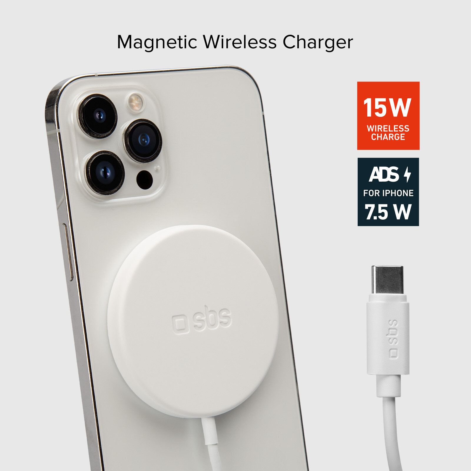 Biały telefon z dołączoną ładowarką bezprzewodową, obok kabel do ładowania. Tekst u góry.