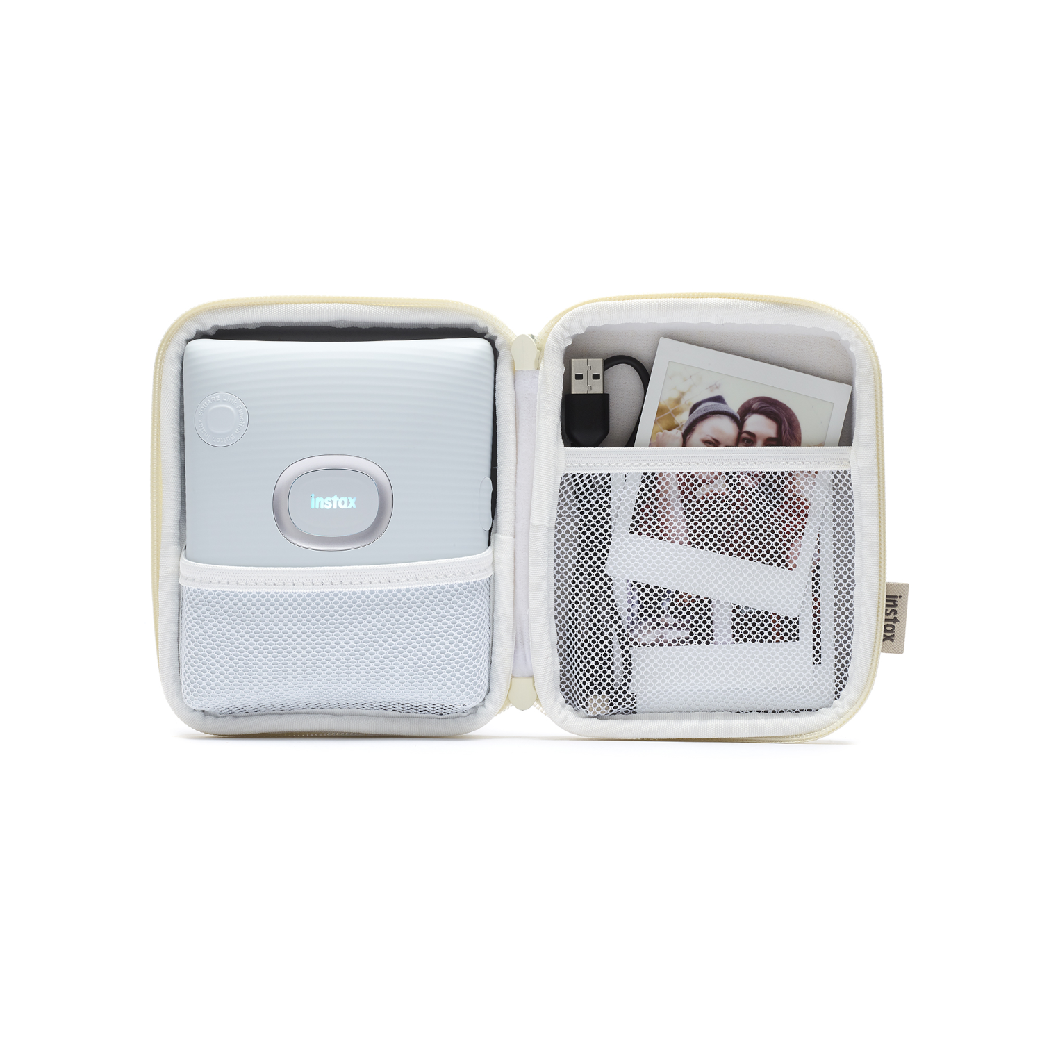 Open case with a light blue Instax Mini printer, a USB cable, and a photo of two people.