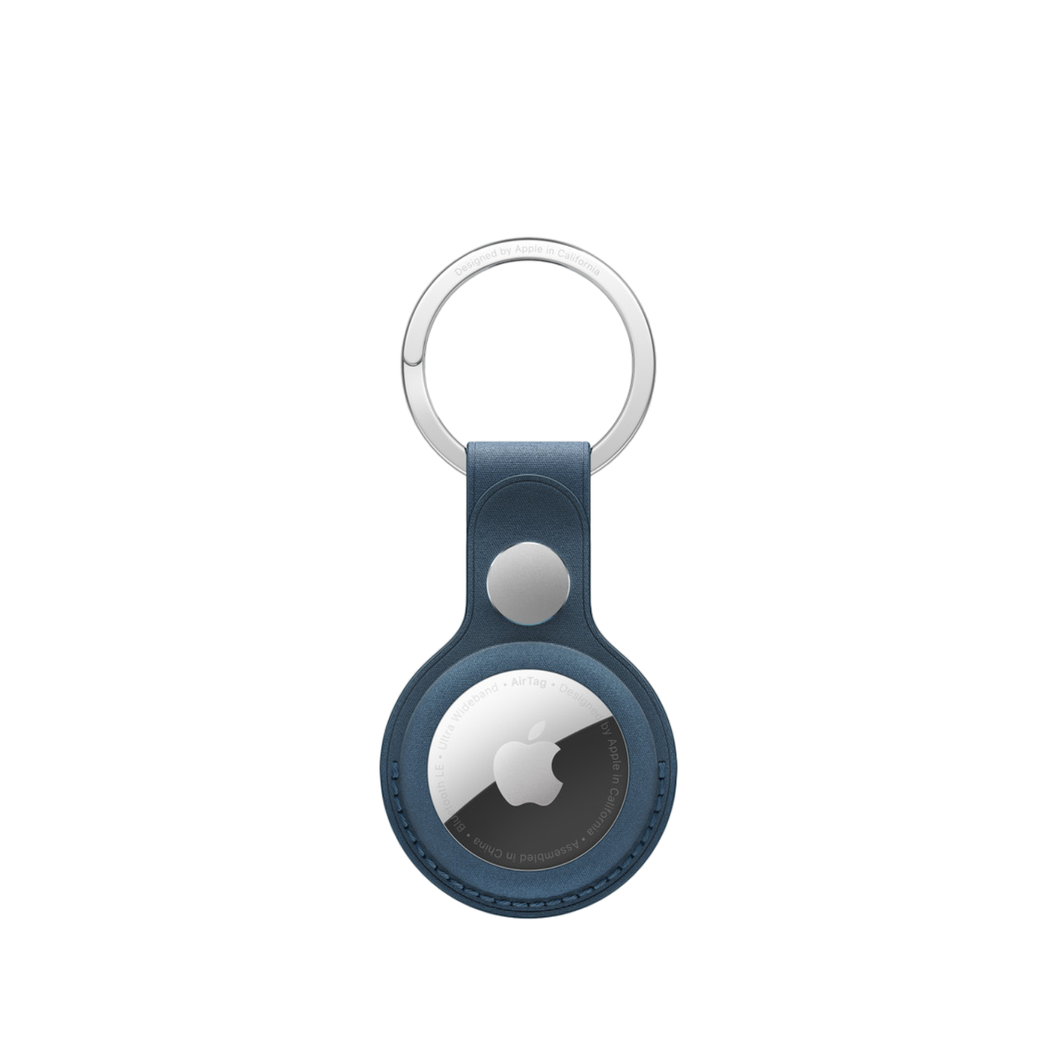 Navy blue AirTag with a silver ring and Apple logo on a dark background.