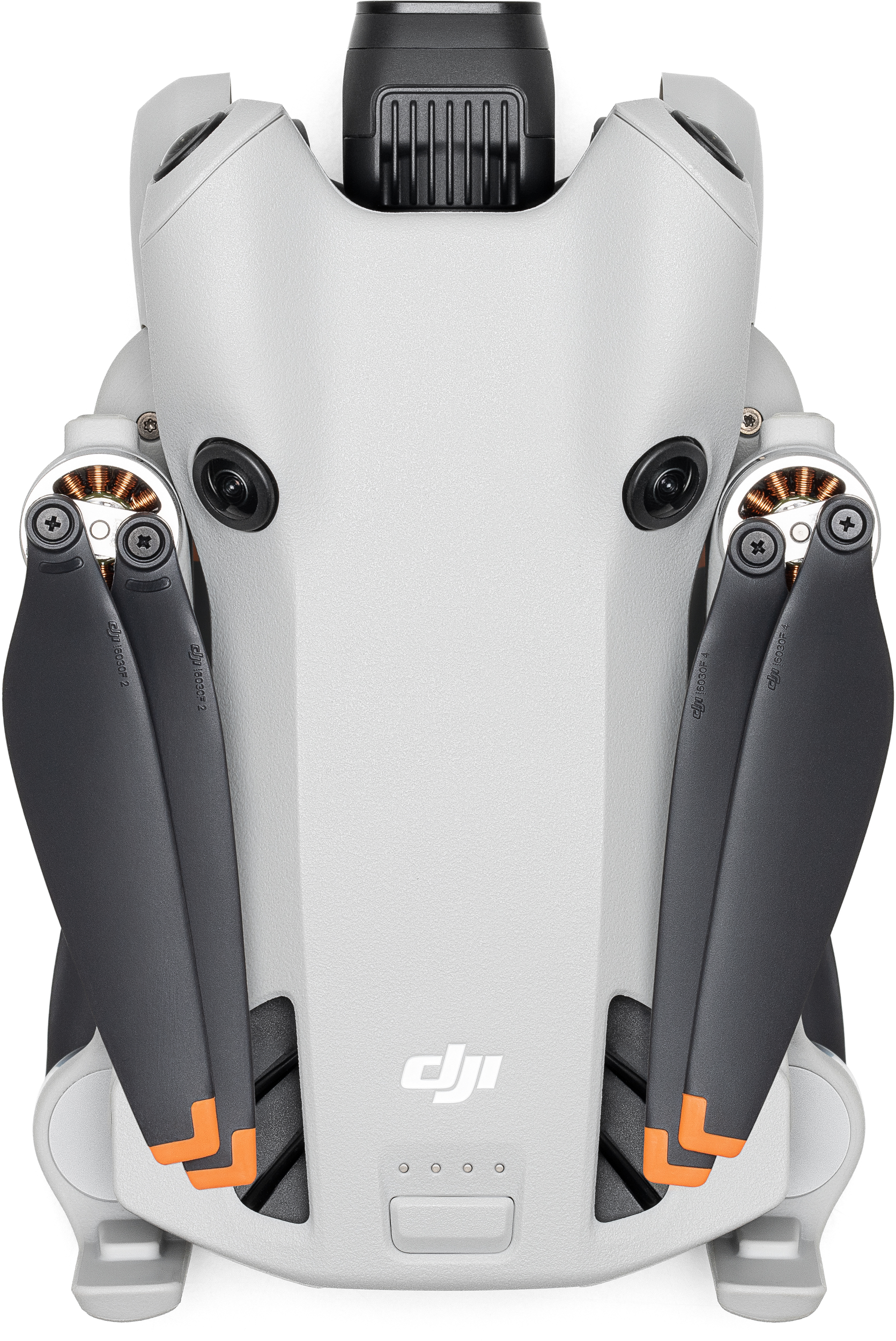 Eine Drohne, Draufsicht, grauer Körper, schwarze Propeller mit orangenen Spitzen und schwarze Sensoraugen.
