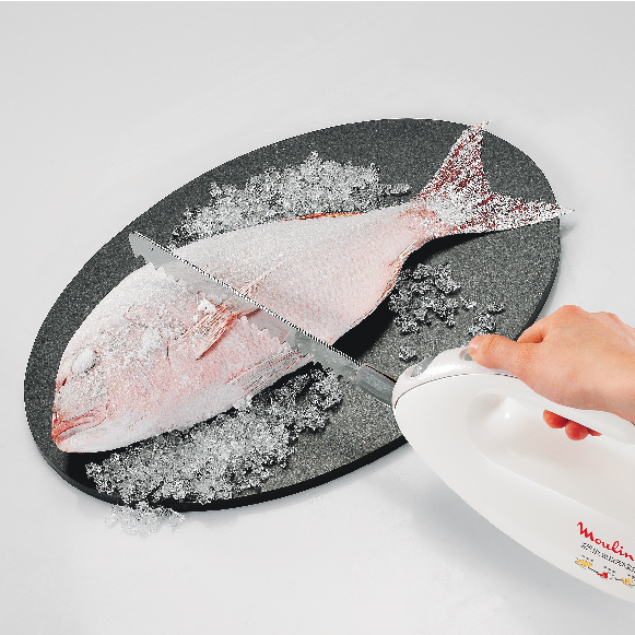 Fish being sliced with an electric knife on a serving platter with ice.