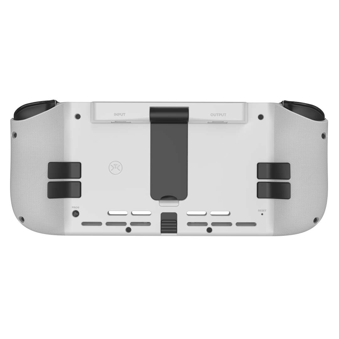Weißes Gaming-Gerät, Rückansicht. Merkmale umfassen Knöpfe, Anschlüsse und einen Ständer. Schwarze Akzente und Design.