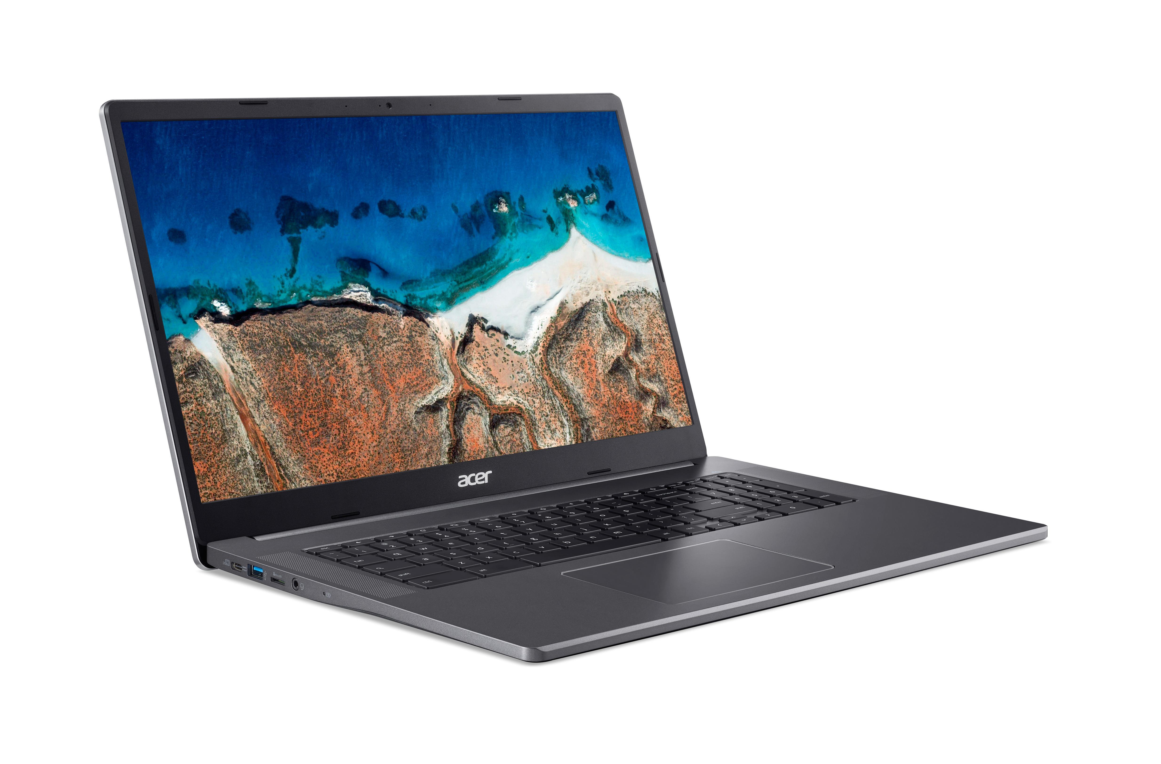 Ein geöffneter Laptop, der eine malerische Küstenlandschaft auf dem Bildschirm zeigt.
