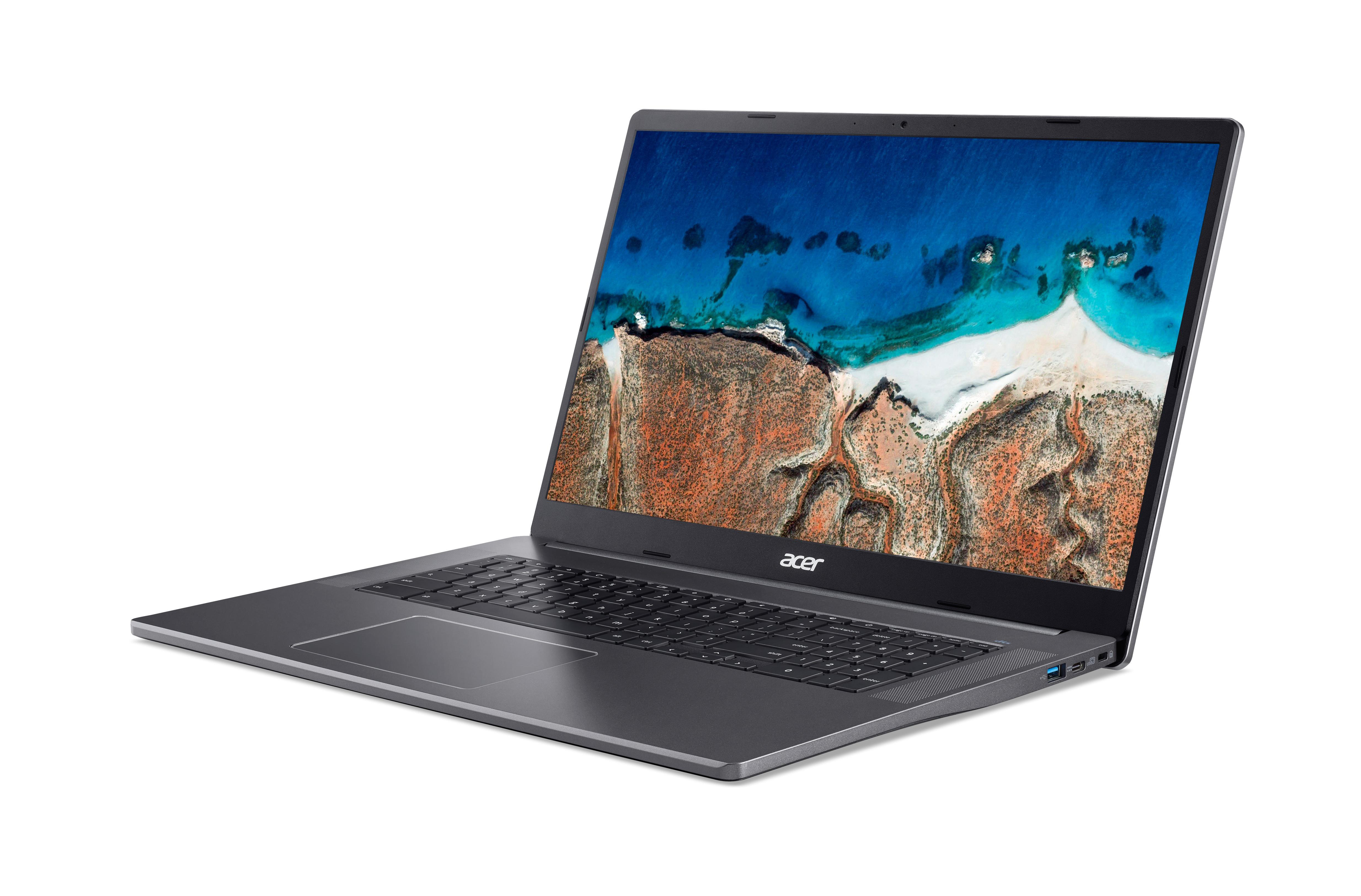 Ein grauer Laptop auf weißer Oberfläche; eine Strandszene ist auf dem Bildschirm.