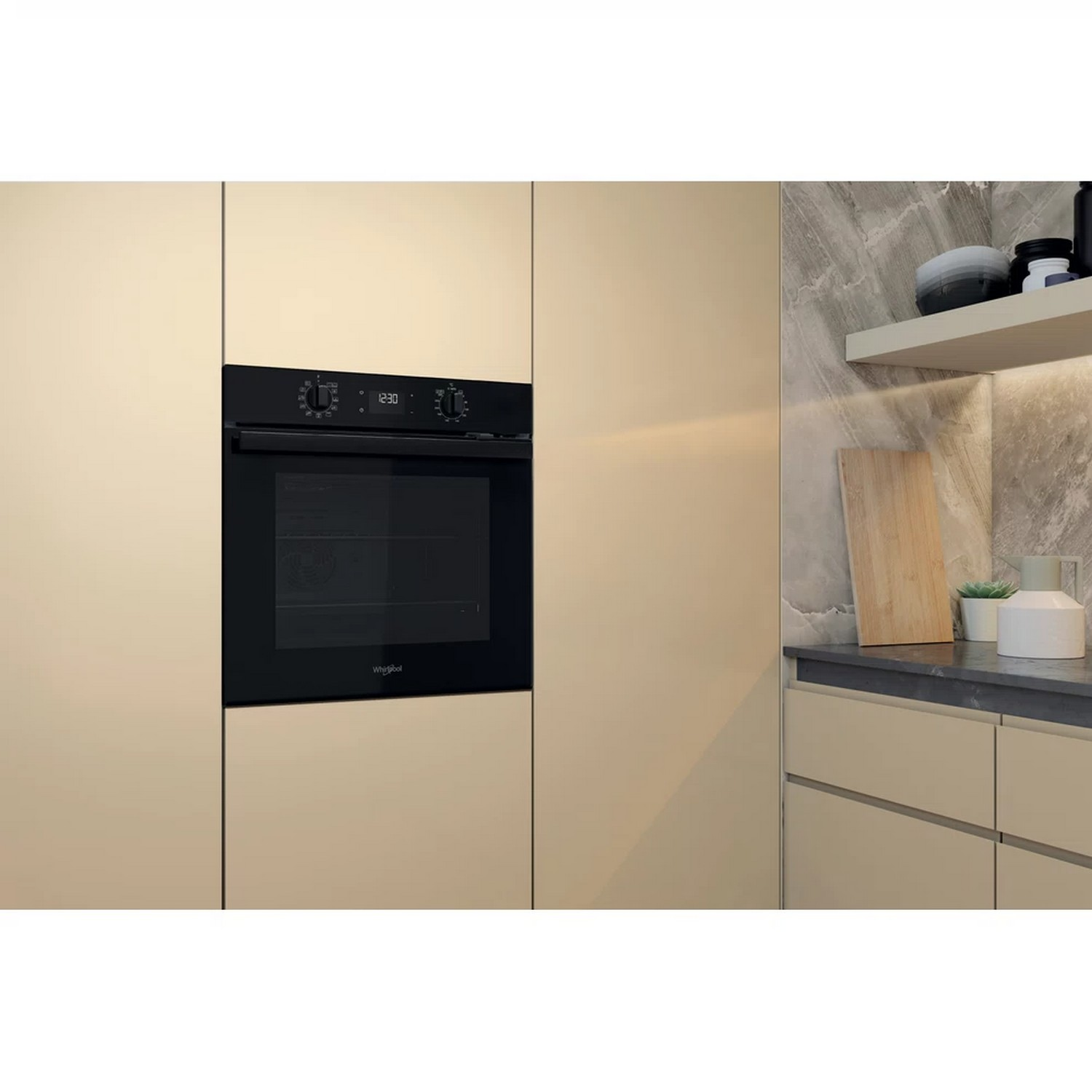 An oven built into a kitchen cabinet. The oven is black with a digital clock.