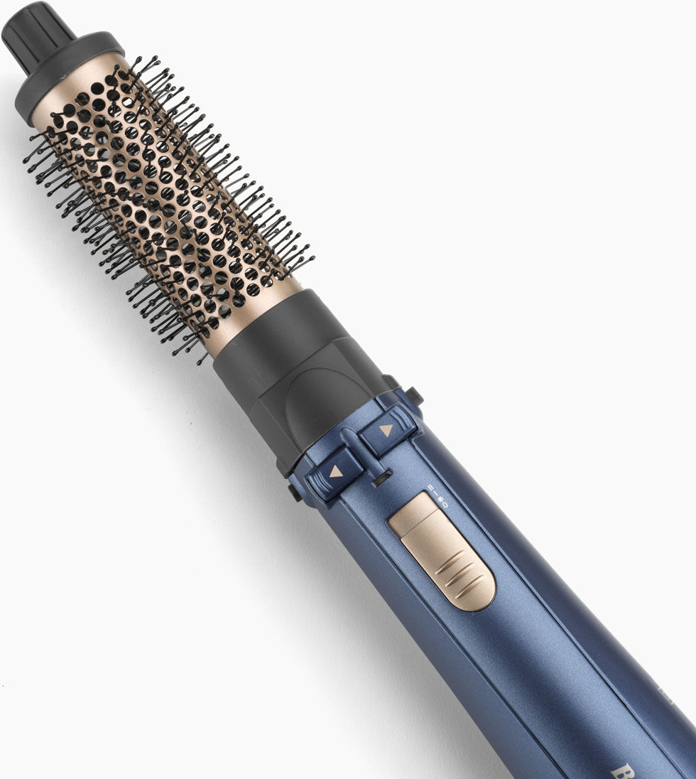 Spazzola per capelli. Manico blu, setole dorate e testina nera visibili.