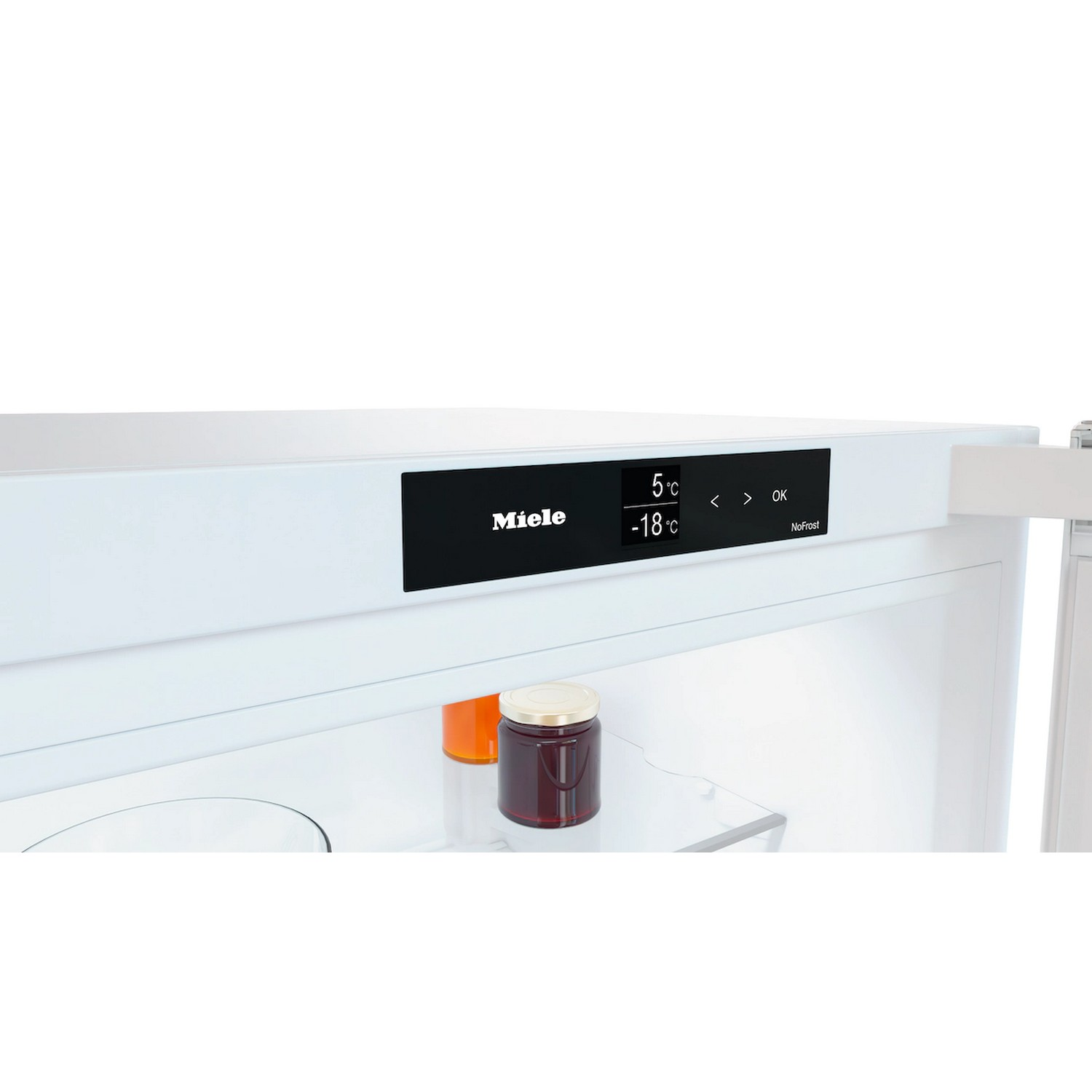Intérieur du réfrigérateur Miele avec bocaux sur une étagère. L'écran affiche la température.