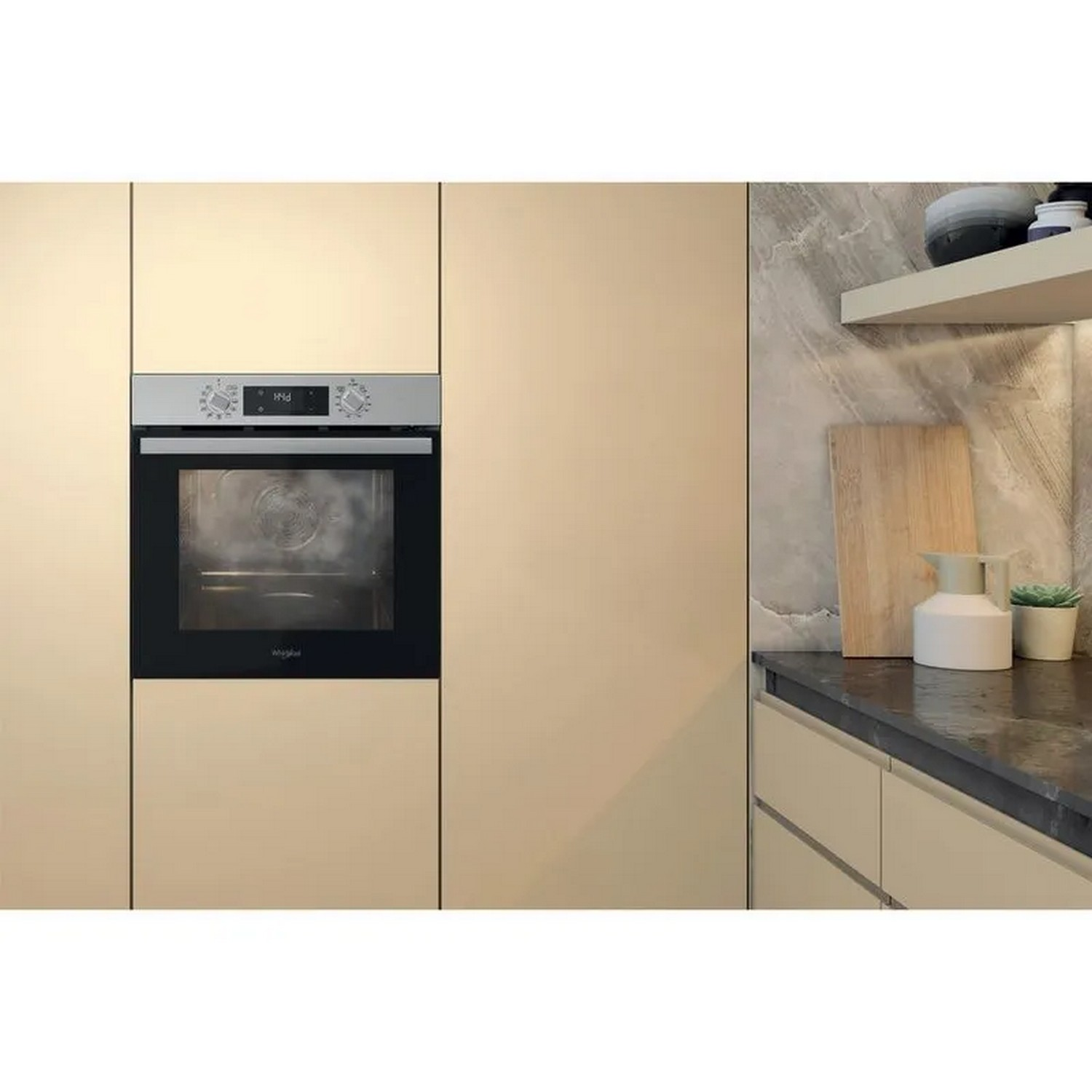 An oven built into a beige kitchen cabinet.