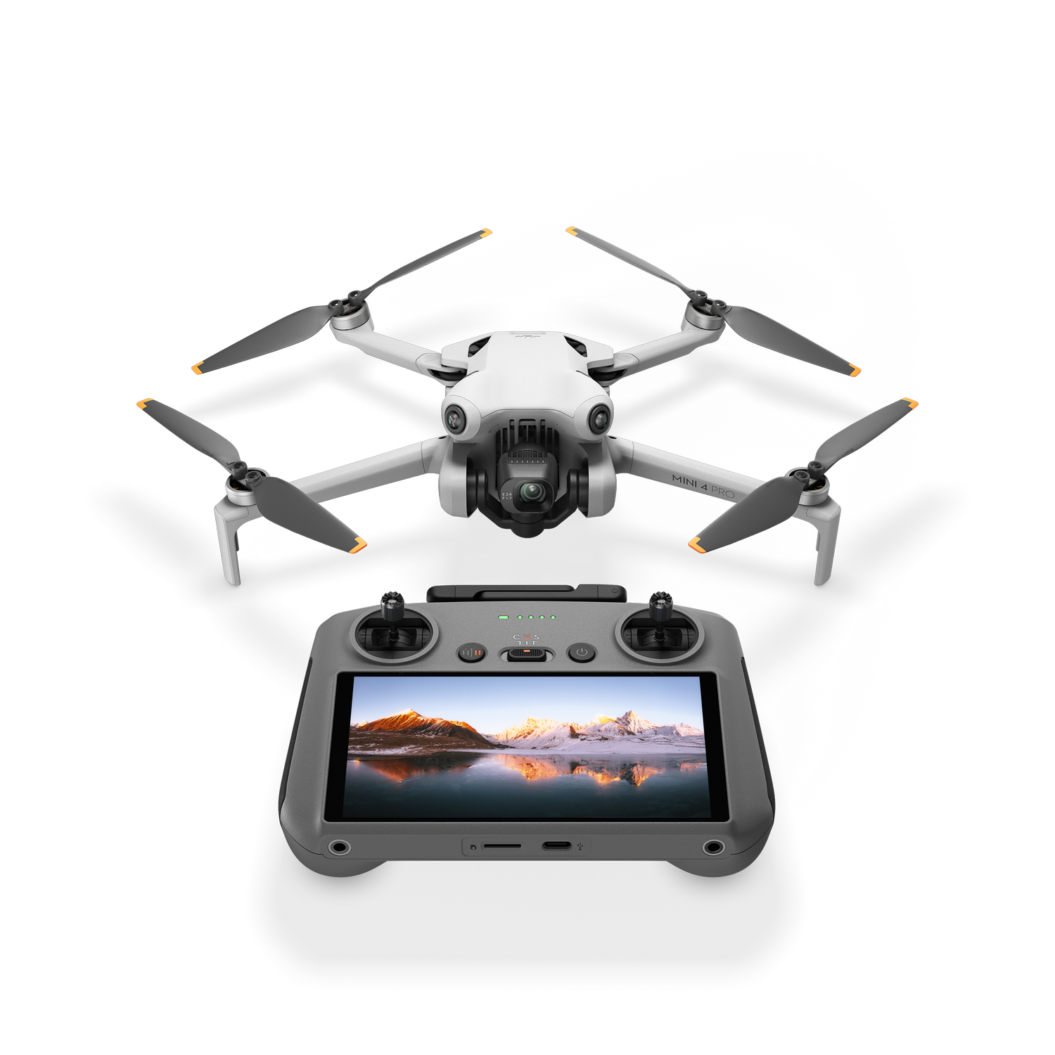 Dron y su control remoto con pantalla, colocados sobre superficie negra.