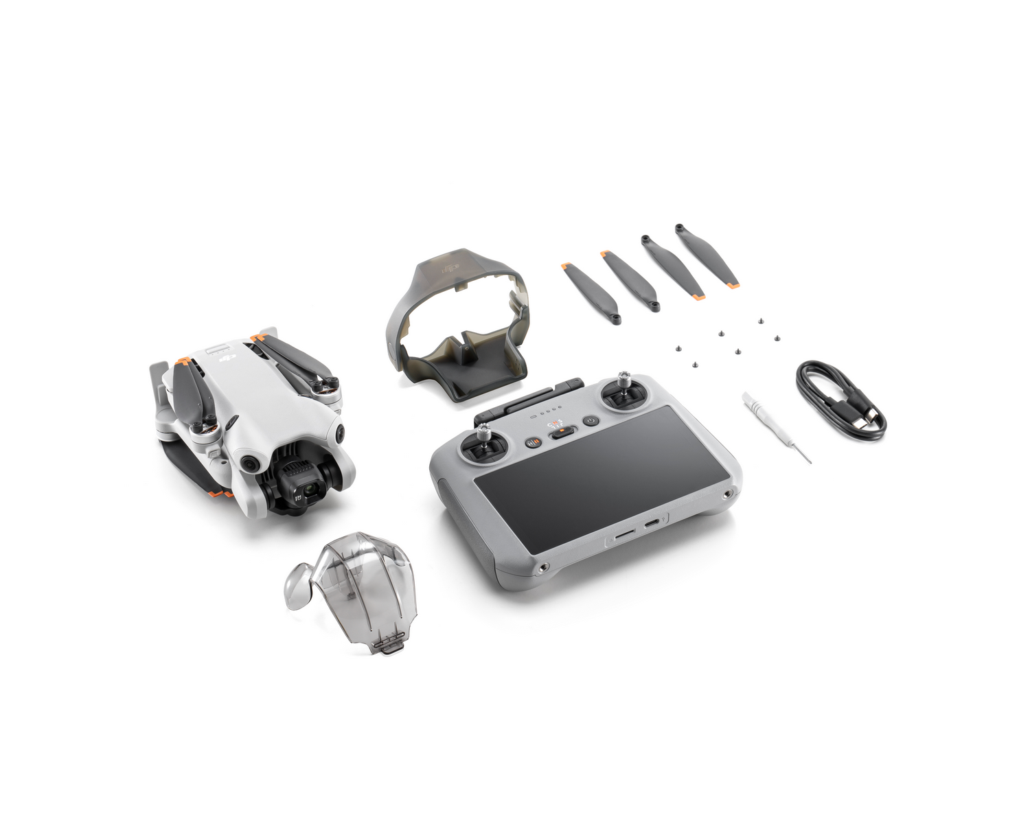 Un dron y sus accesorios, incluyendo un controlador, hélices y un estuche.