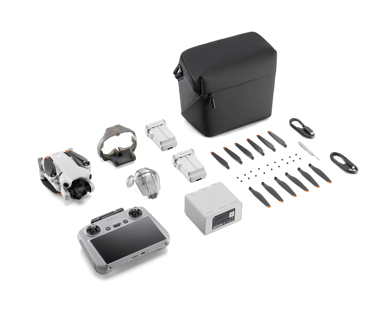 Kit de dron: dron, mando, gafas, baterías, hélices, cargador y estuche.