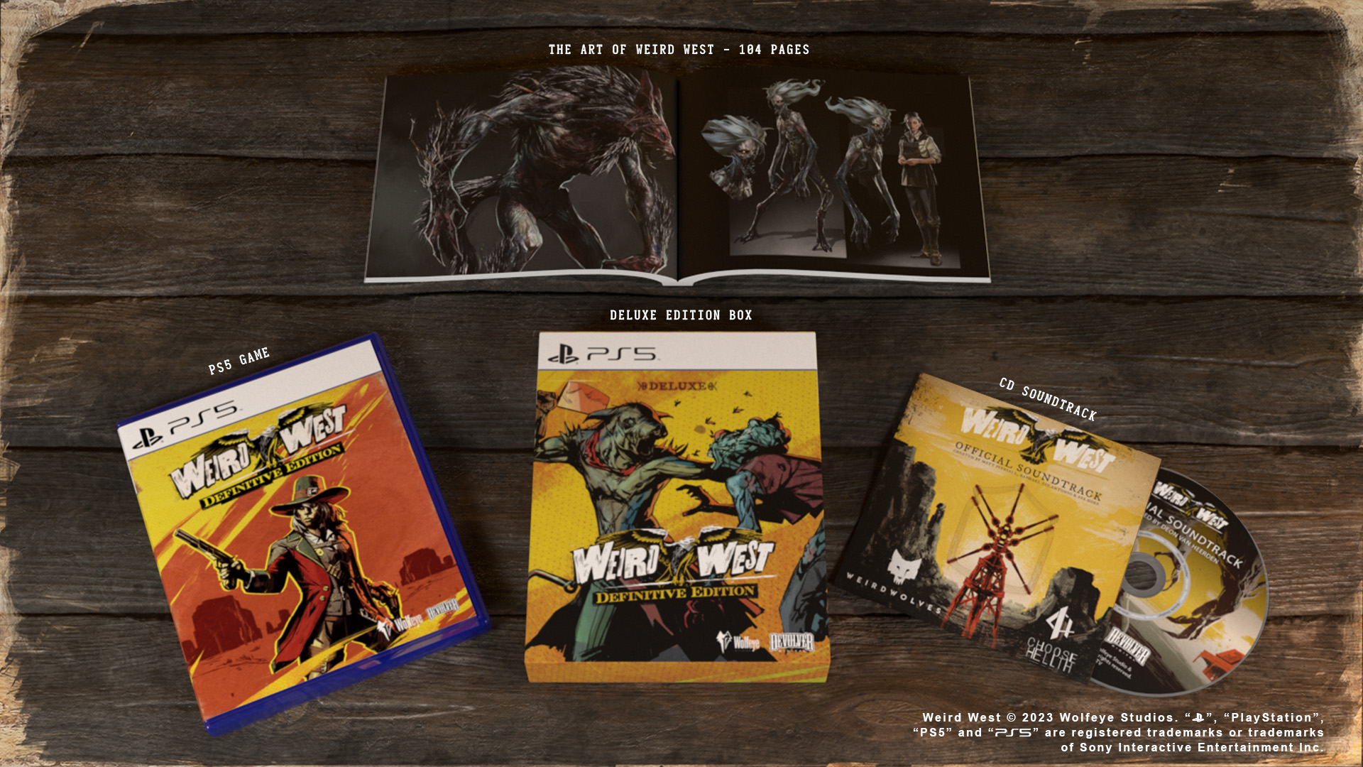 Weird West Deluxe Edition dobozkészlet és kapcsolódó elemek fa felületen. Tartalmazza a játékot, a filmzenét és a művészeti könyvet.