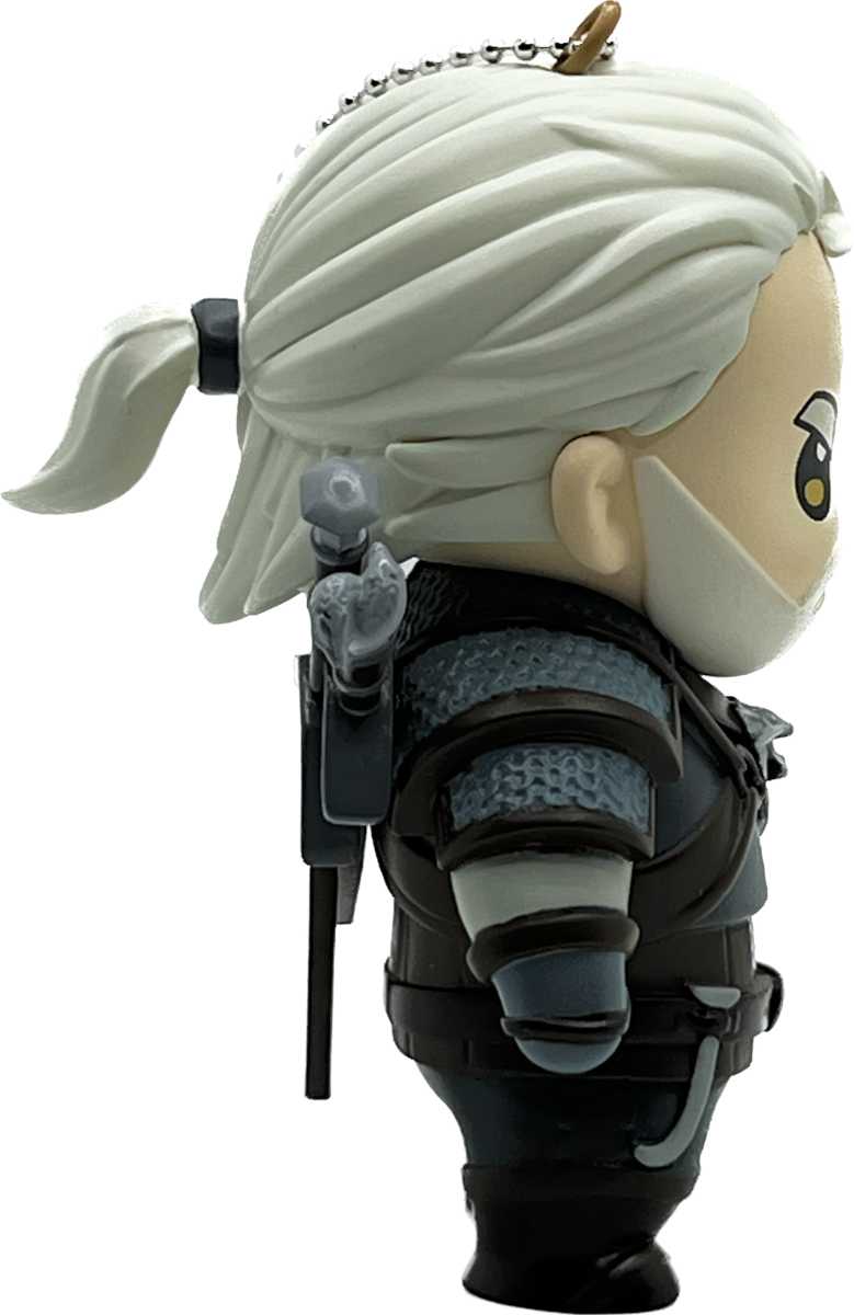 Egy kis figura egy Witcher karakterről, fehér lófarokkal.