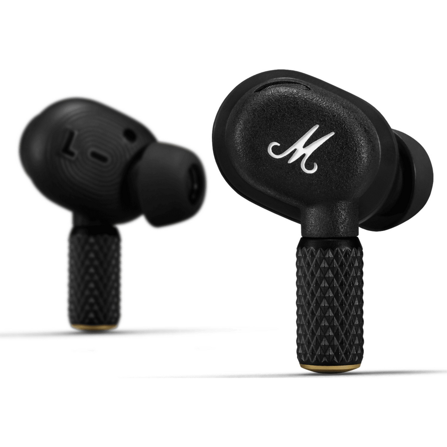 Black wireless earbuds with a stylized 'M' logo. One earbud is in focus, the other blurred in the background.