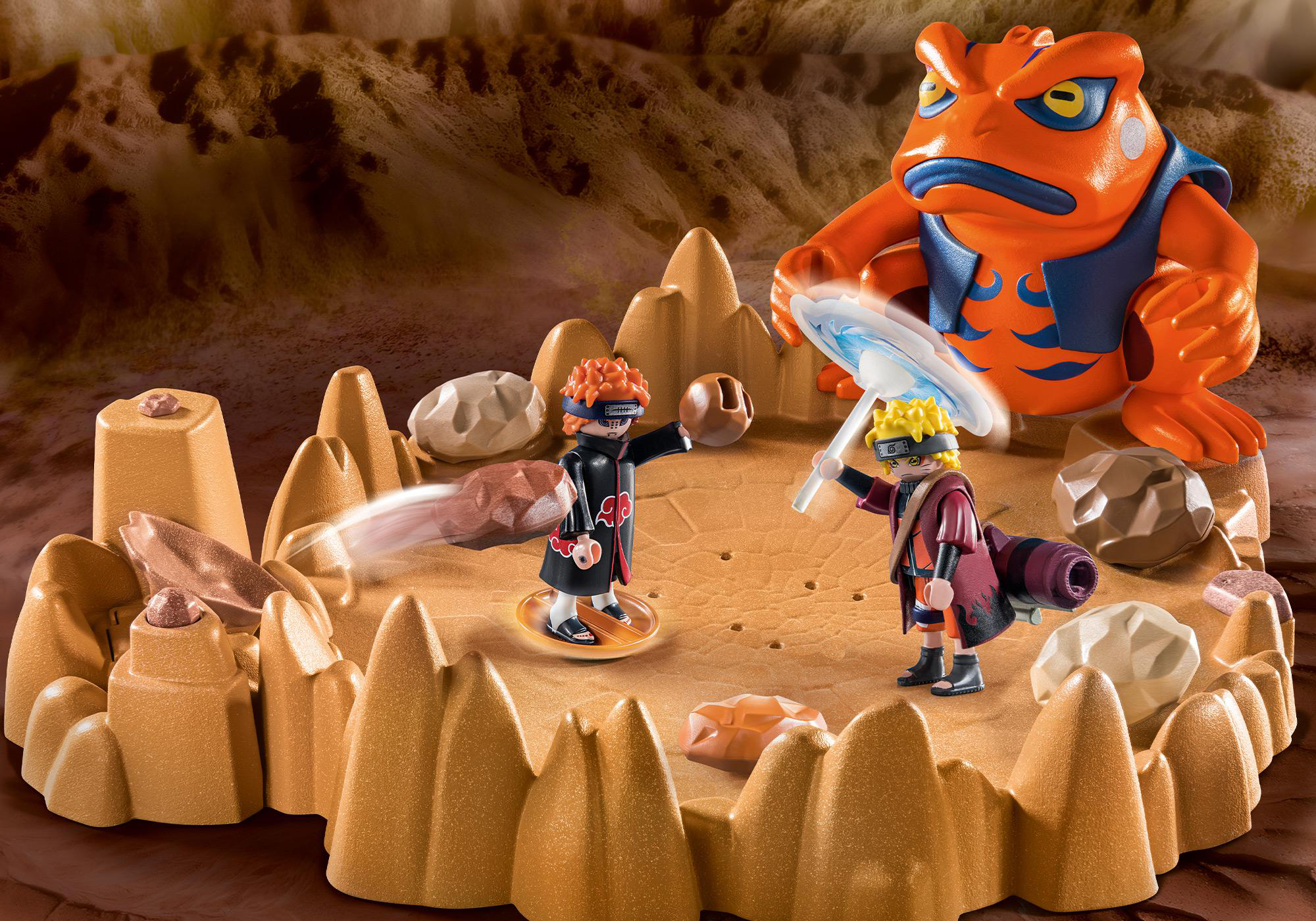 Playmobil-Set mit Figuren in einer Wüstenszene, mit einem großen orangen Frosch.