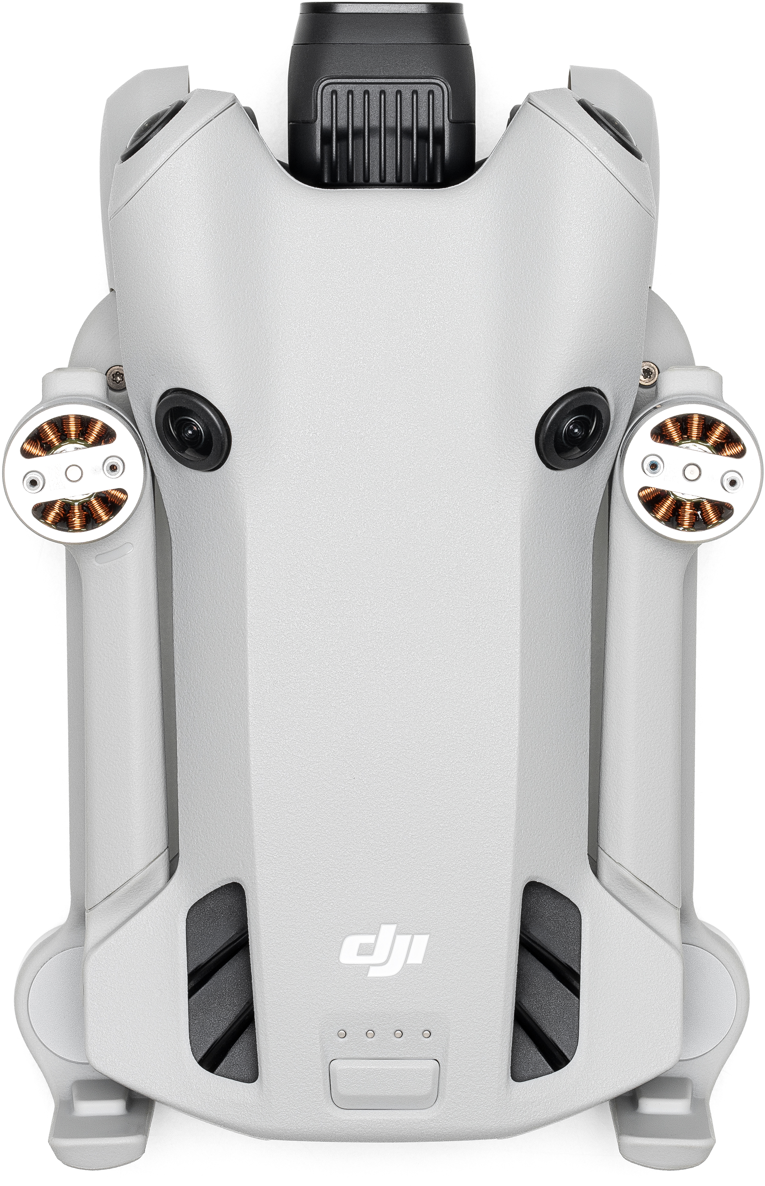 Un drone gris vu d'en haut. Il a des hélices, des caméras noires et le logo DJI en bas.