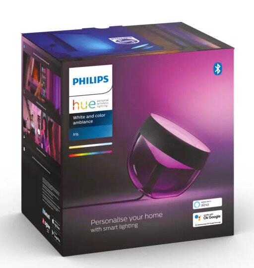 Lampa Philips Hue Iris w pudełku. Lampa jest czarno-biała. Pudełko ma różowy gradient.