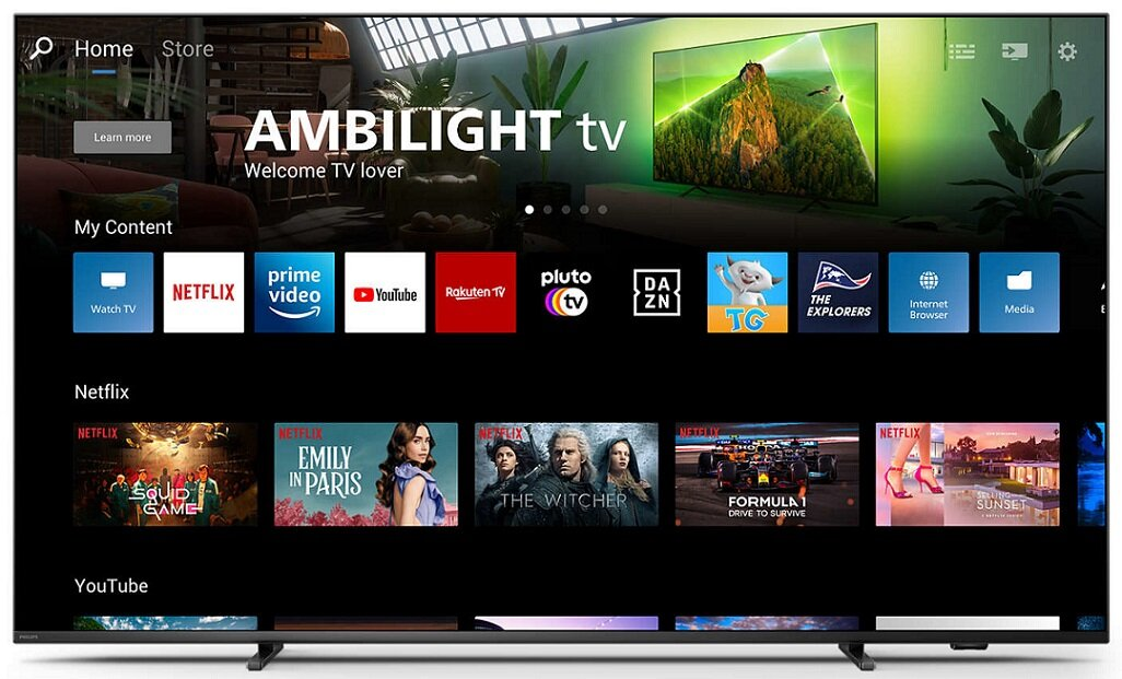 Duży ekran telewizora wyświetlający interfejs z ikonami aplikacji i opcjami treści. Telewizor jest czarny.