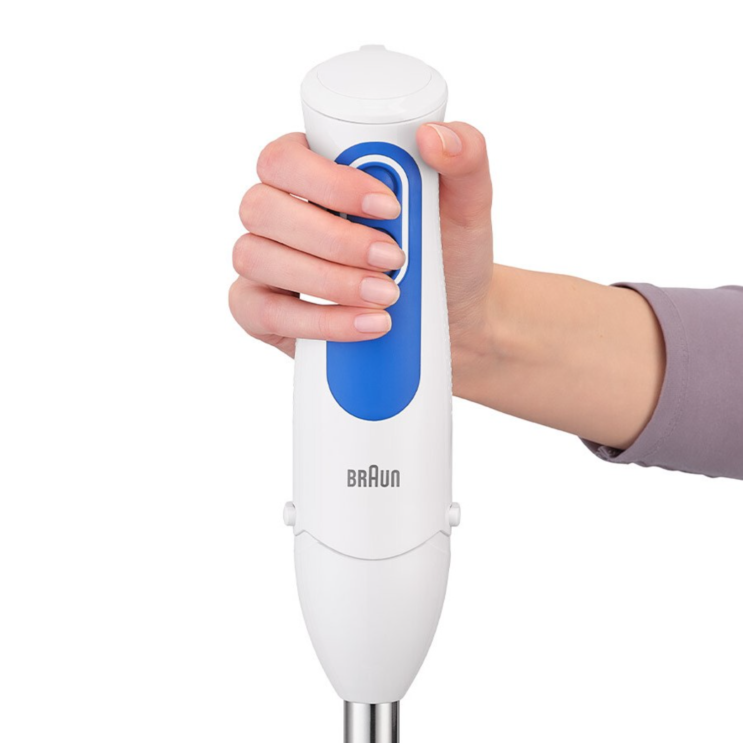A hand holding a white and blue Braun immersion blender.