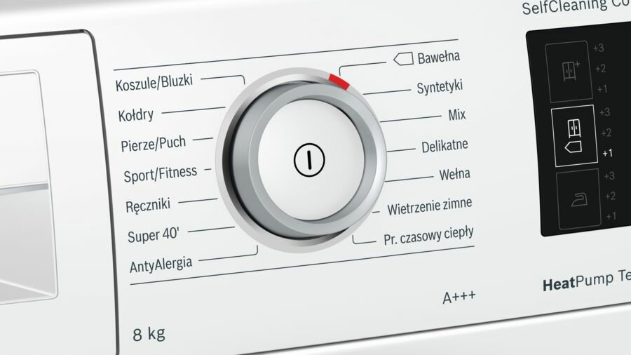 Panel sterowania pralki z pokrętłem i etykietami tekstowymi w języku polskim, zbliżenie.