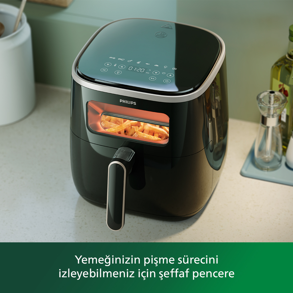 Siyah Philips airfryer, içinde patates kızartması var. Metin: Pişirme sürecini görebilirsiniz.