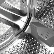 Wnętrze bębna pralki z otworami. Stal nierdzewna z łopatką.