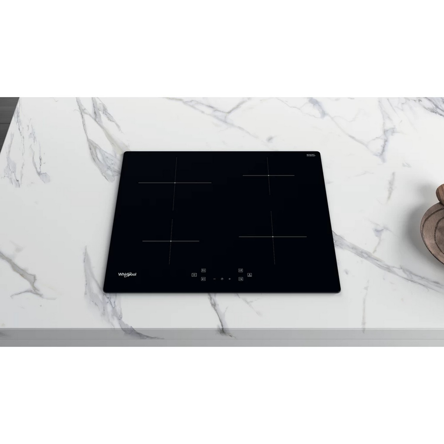 Black induction cooktop on a marble countertop, four burners, Whirlpool logo visible.