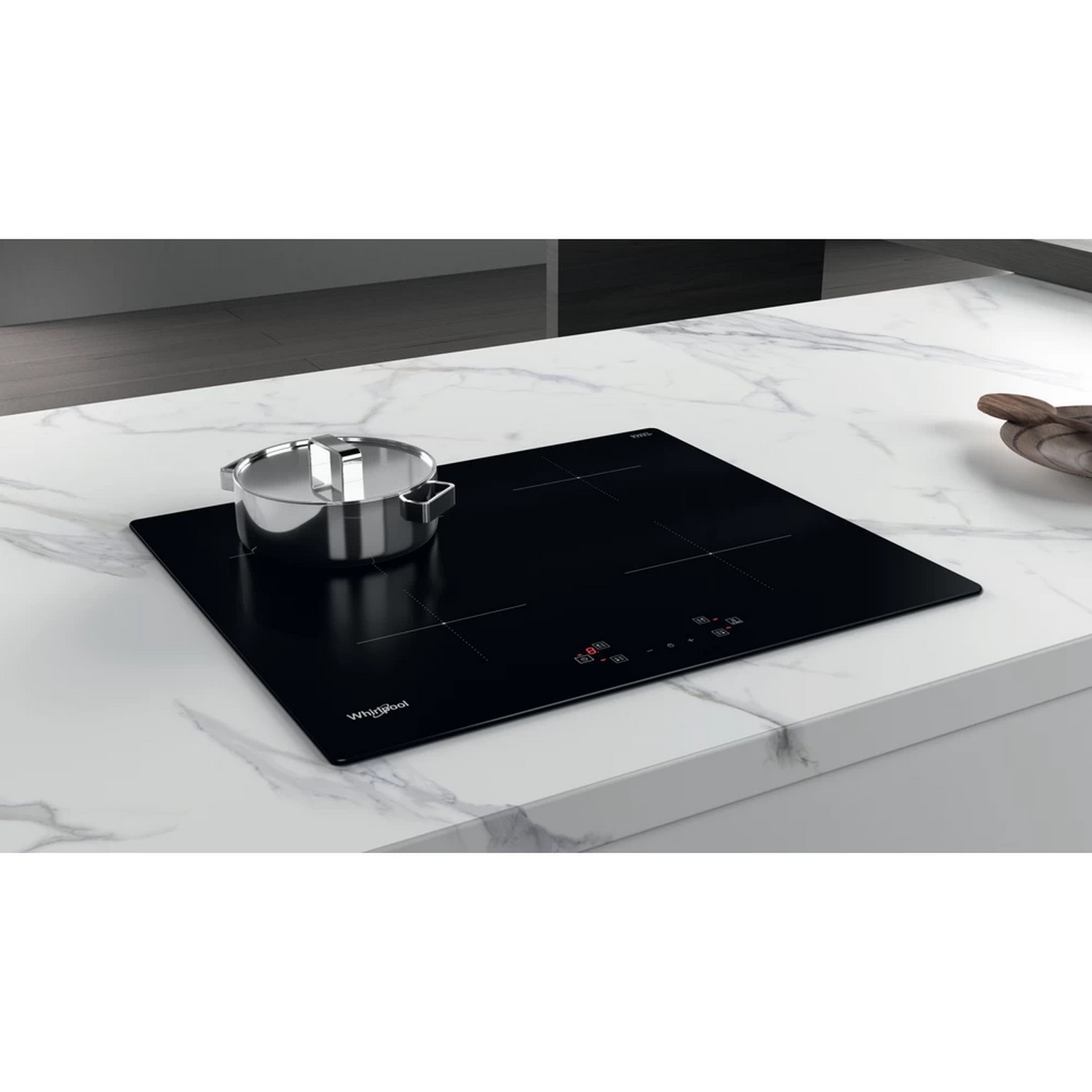 Black induction cooktop on a marble countertop. A pot sits on it.