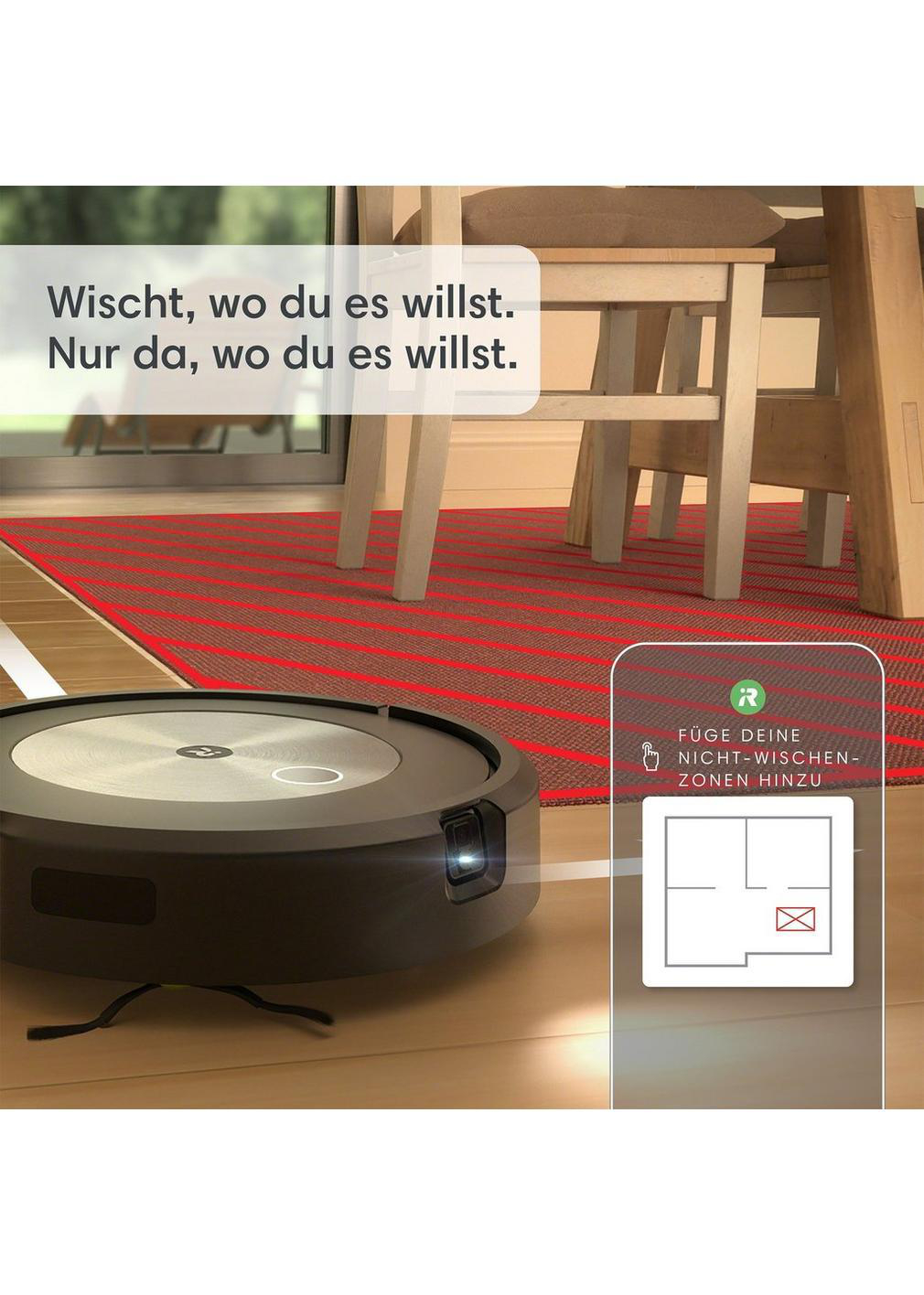 Ein Roboter-Staubsauger auf Holzboden, mit rotem Teppich im Hintergrund.