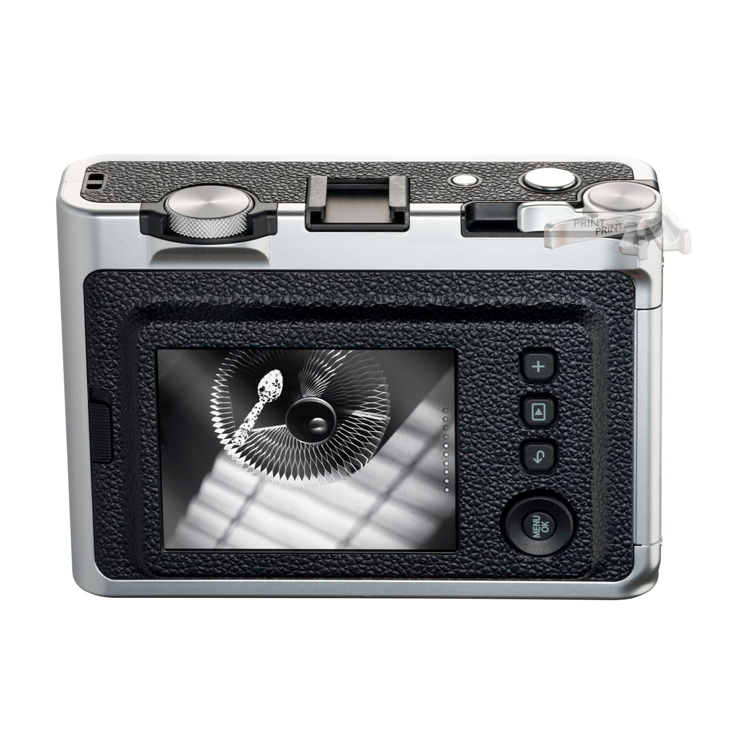 Retrocamera nera e argento con schermo che mostra un motivo circolare, pulsanti e manopole.