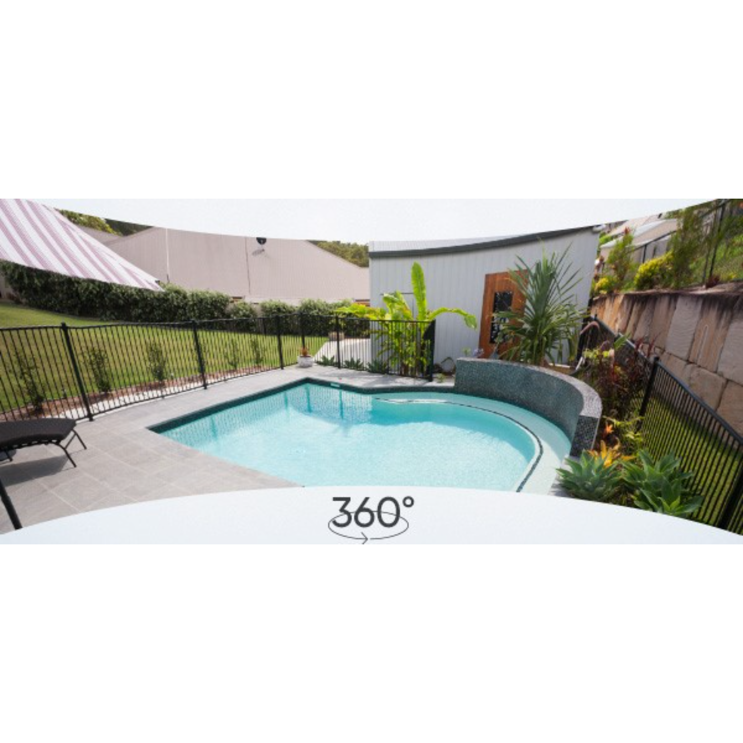 A 360° view of a backyard with a pool, fence, and buildings.