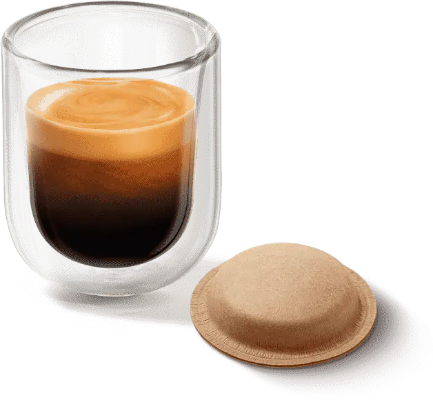 Espresso in einer Glastasse, daneben eine Kaffeekapsel.